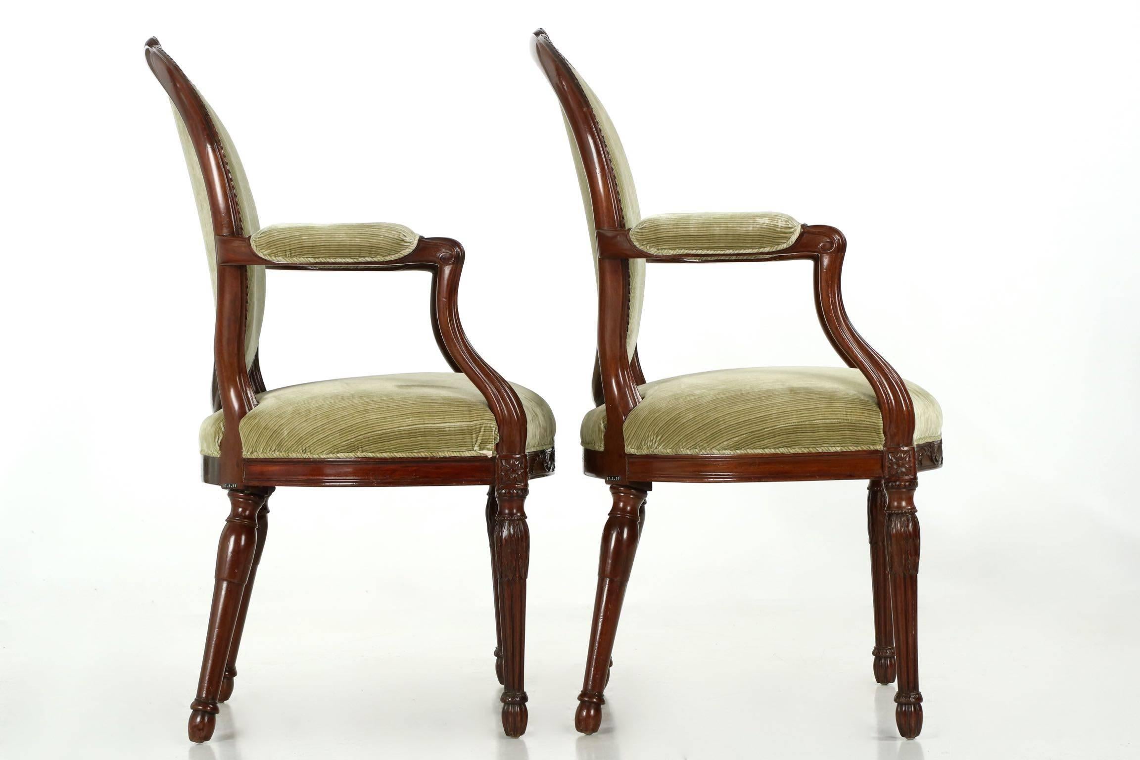 Each with exceedingly well carved surfaces and professionally conserved solid mahogany frames, this pair of George III period fauteuils exude a strength and sense of balance in form that is most striking. The design perfectly balances the angular