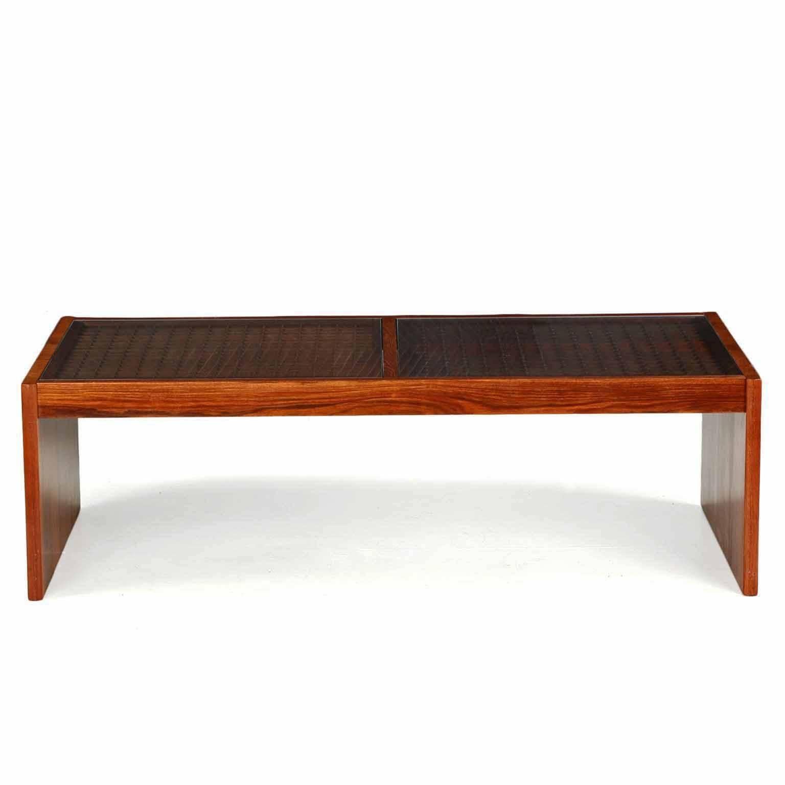 An attractive and angular coffee table retaining its original label by Komfort in Denmark, this version is finished in gorgeous and vibrant rosewood veneers as opposed to the more common teak version. The top is composed of two removable glass