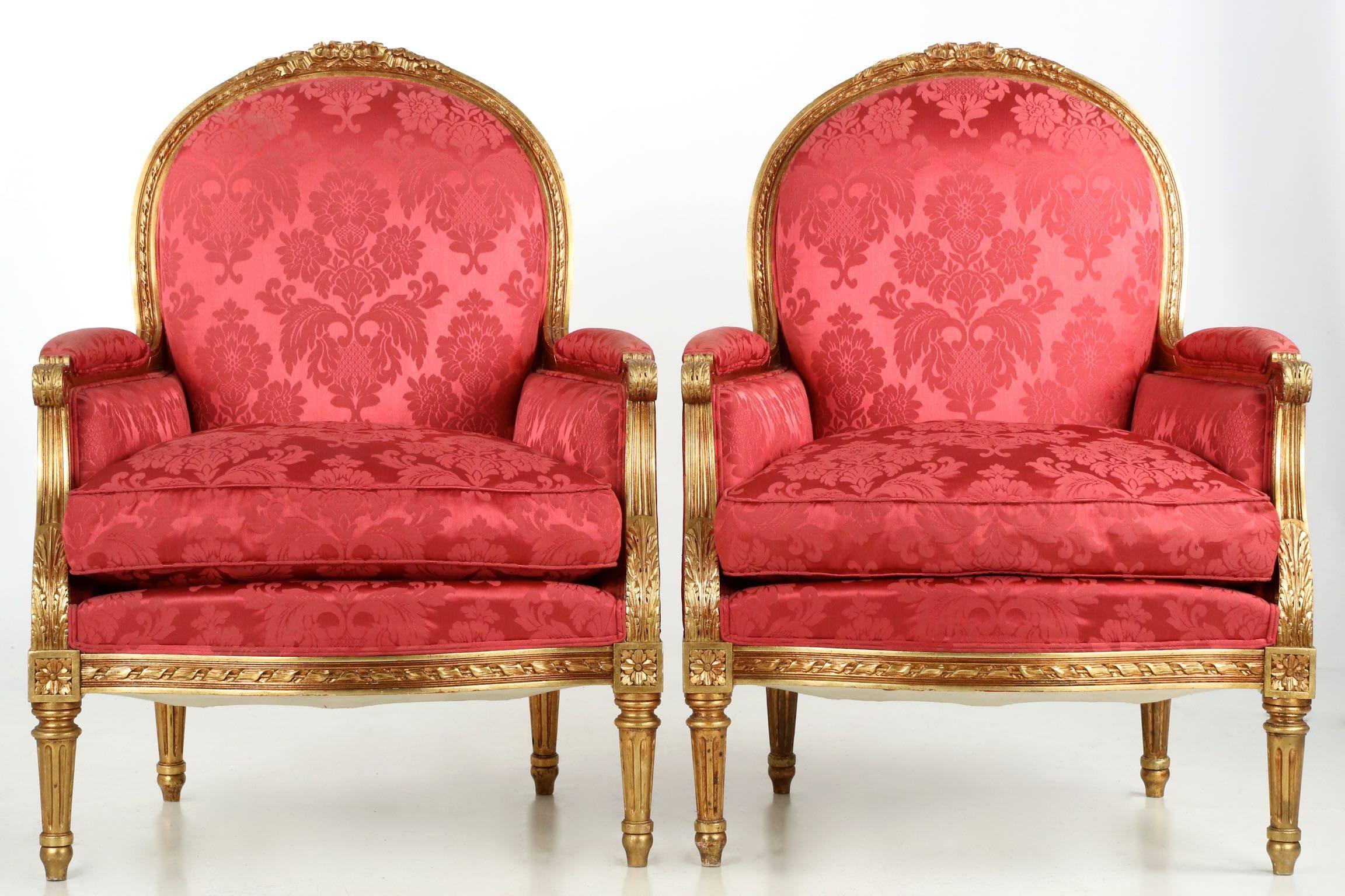 This refined pair of Louis XVI style bergère is crafted with careful attention to detail. An exacting reproduction of the original forms, the chairs are crafted of solid beechwood that has been expertly carved with an intricate display of twisted
