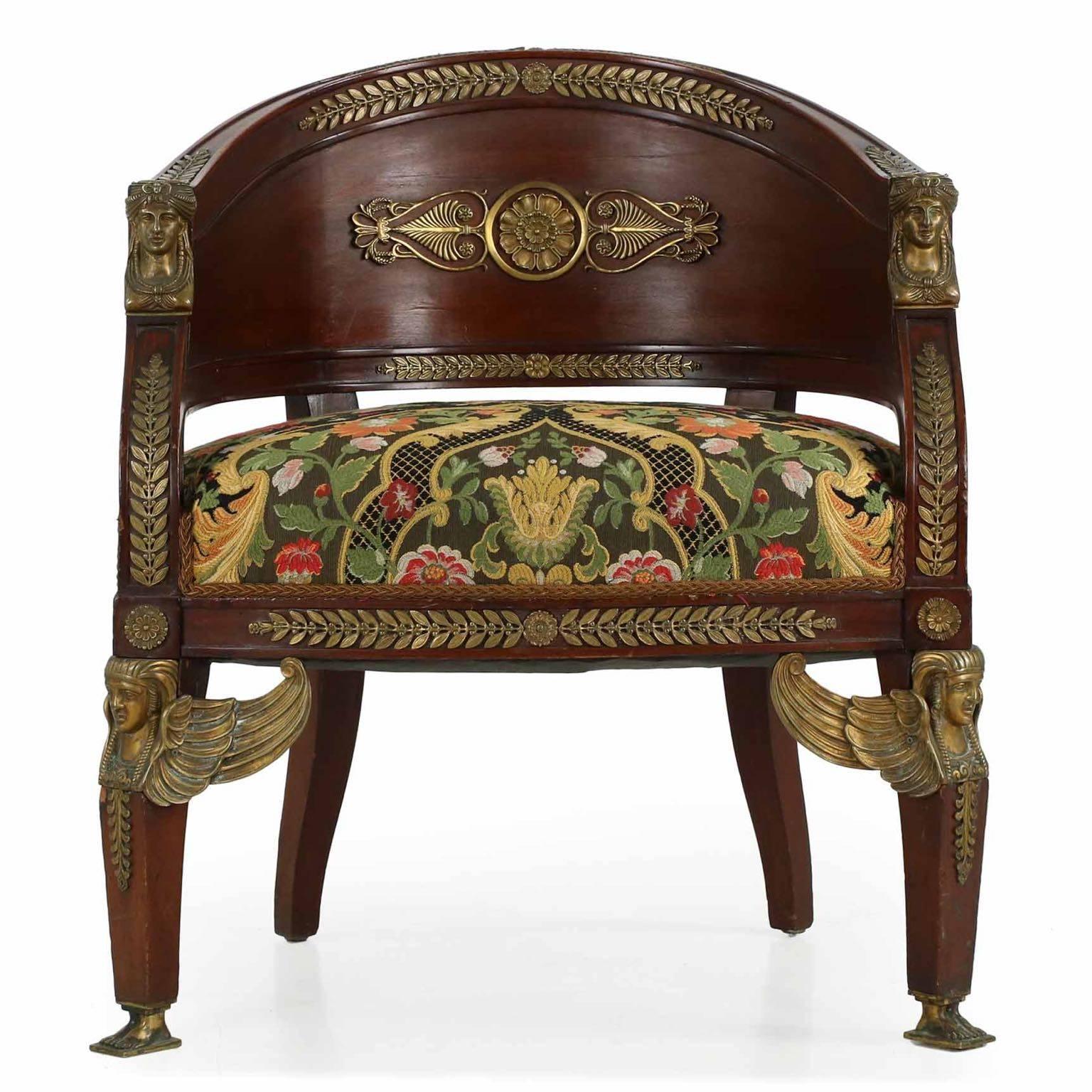 Of unusually interesting stance and form, this Egyptian Revival chair was crafted during or just after the reign of Napoleon III during the third quarter of the 19th century. Strength and boldness are projected in the unending stream of beautifully