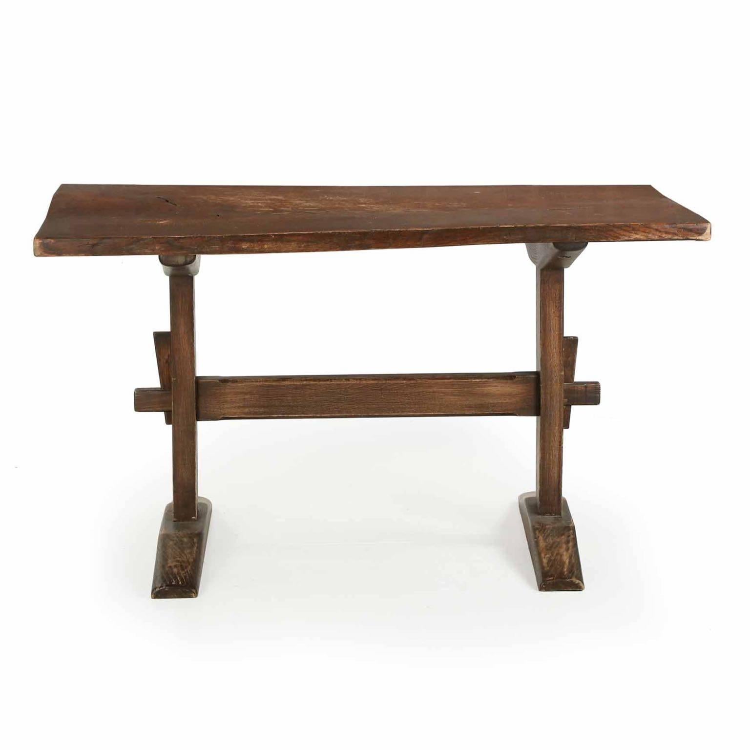 This is a quite attractive and relatively small trestle style library table with the strictly utilitarian construction preferred during throughout the Arts & Crafts movement.  There is a Shaker-like simplicity, the symmetry between the footings and