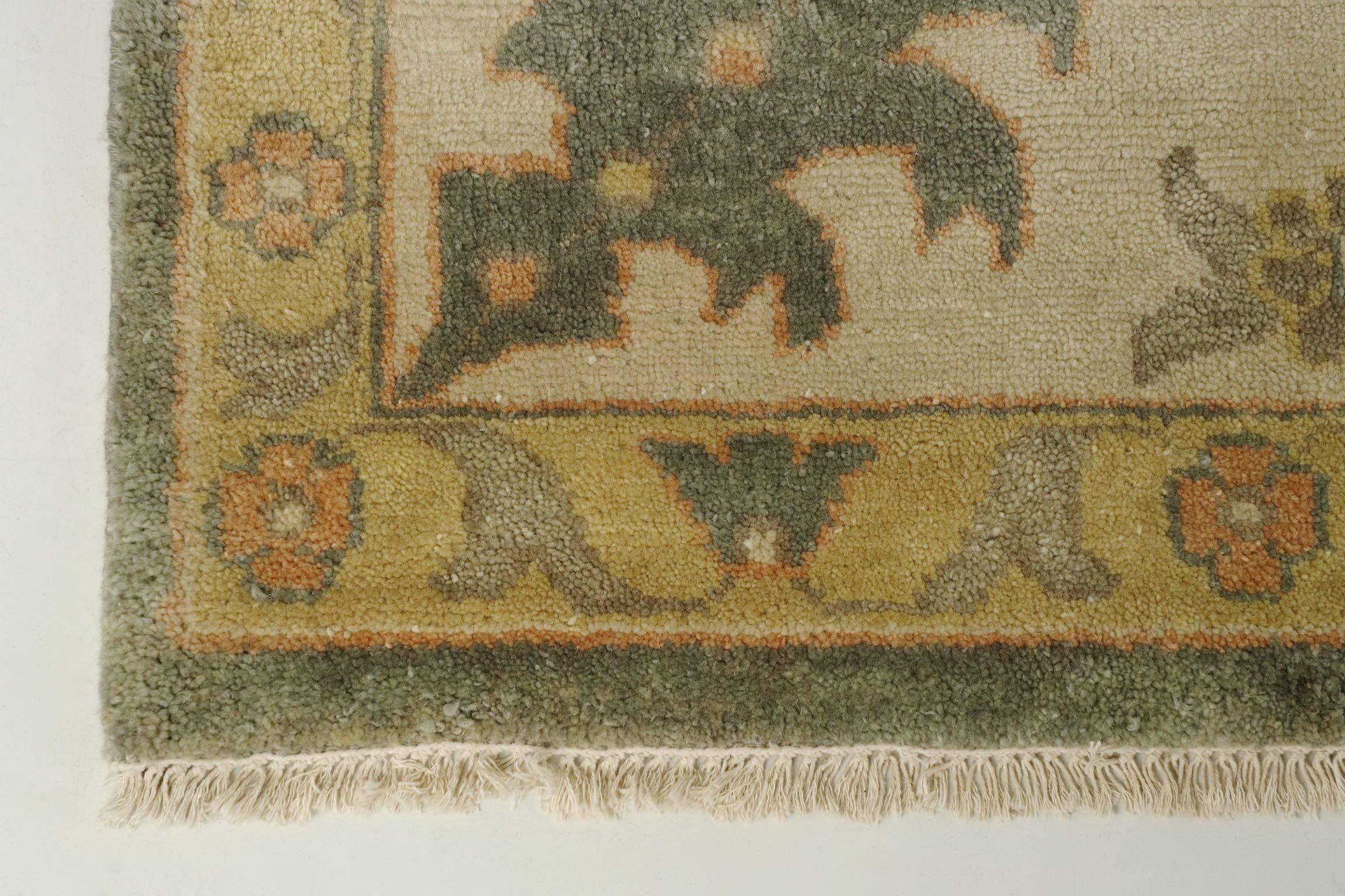 A classic rug design that borrows heavily from the classical Persian motifs of the 19th century, this piece is beautifully hand-knotted with an attractive low-chroma palette.  The low saturation tealish-gray of the primary ground allows a sharp
