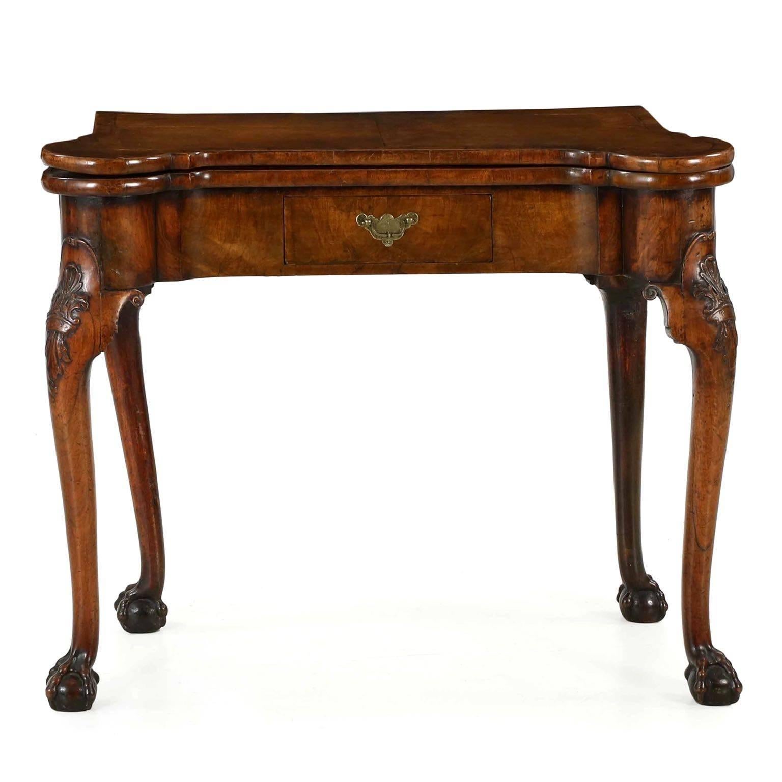 An exceptional and finely preserved piece from the third quarter of the 18th century, this card table remains in exquisite condition and purity throughout. Vibrant and beautifully patinated walnut veneers and solid woods simply glow from centuries