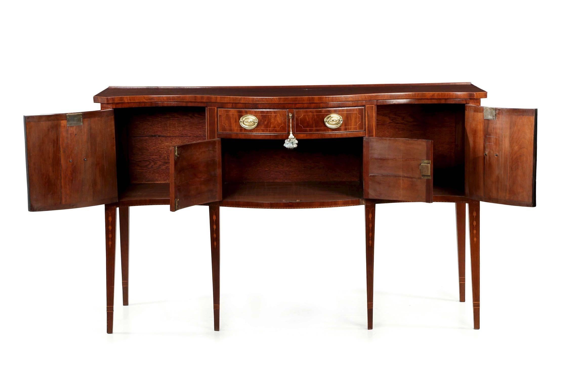 This gorgeous handmade sideboard is executed in the taste of the prior century in the spirit of the Centennial. Precise and finely crafted, the sideboard boasts excellent choice in mahogany, both veneered and of the solid. The top has a soft