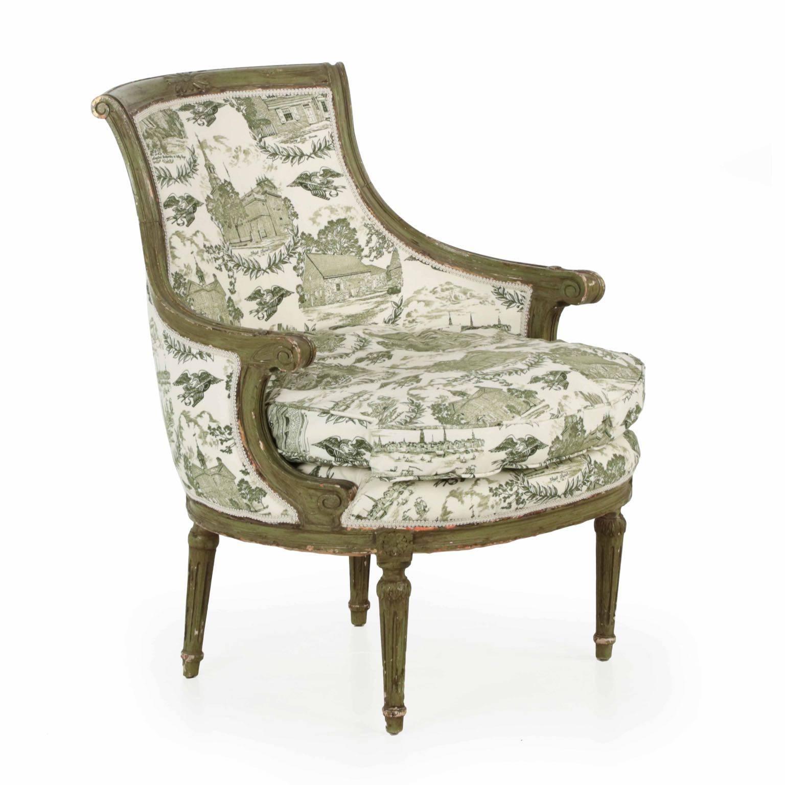 A most attractive rounded bergère in the Louis XVI taste, it is rather unusual and a particularly interesting strikepoint. Only sparingly carved and embellished, the sloped crest is highlighted at the center with a carved floral embellishment, the