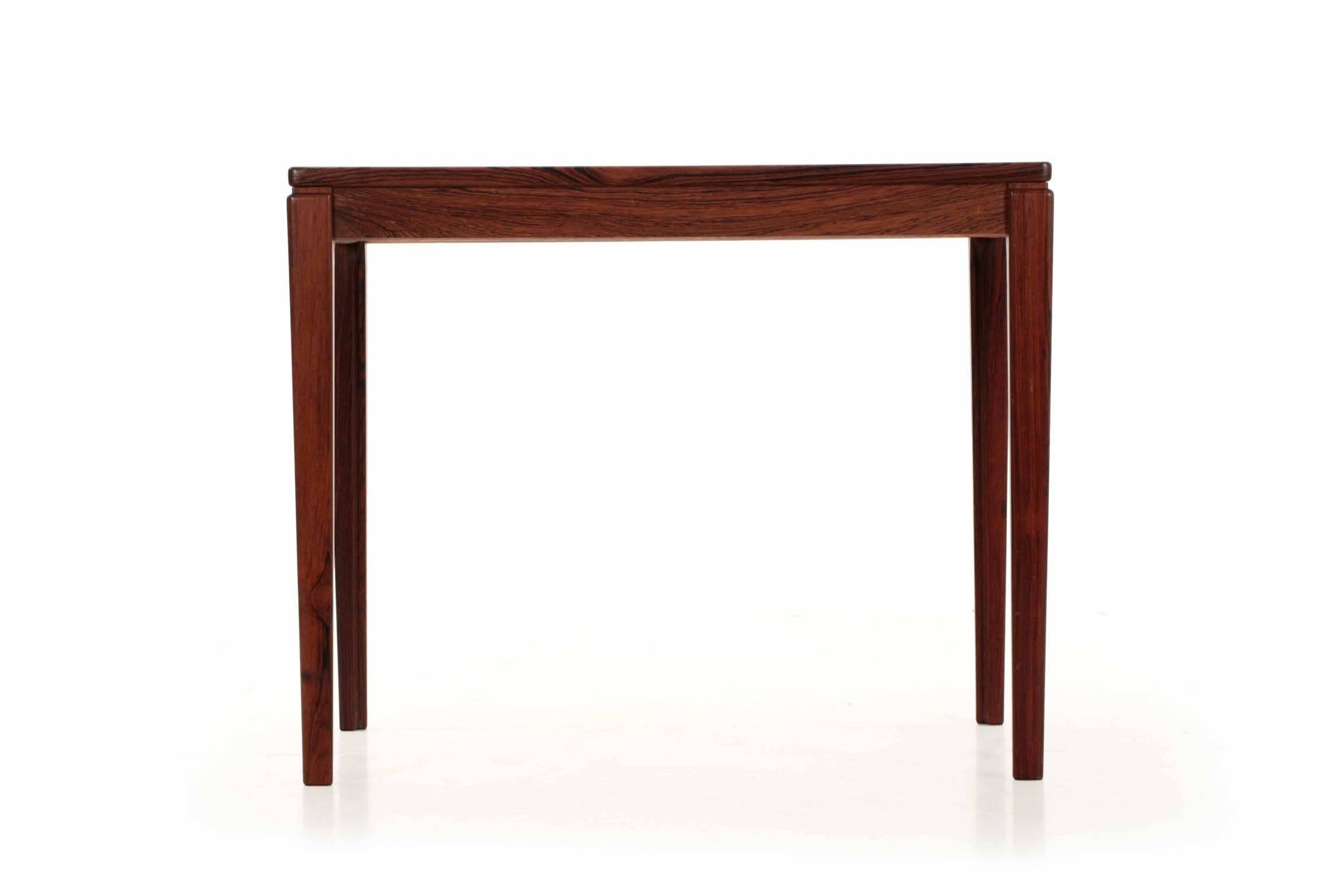 This most attractive rosewood veneered side table was manufactured by Ulferts Møbler of Sweden; it remains in outstanding condition with vibrant color in the chaotic grain of rosewood. The legs are beautifully tapered with a routed inner corner and