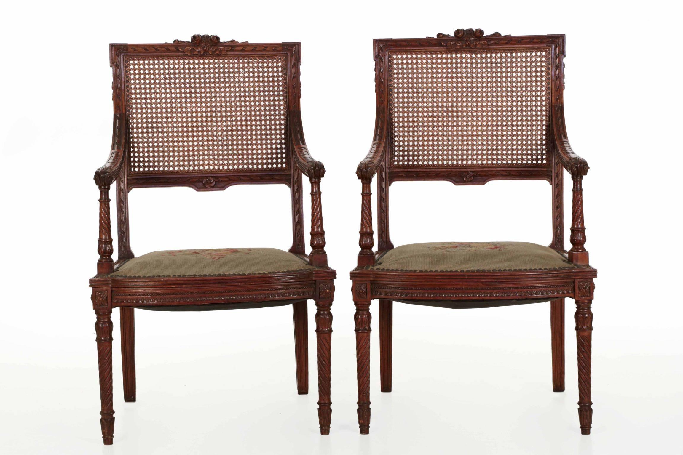 The crisp carved surface embellishment of these neoclassical chairs is noteworthy, the hand carved detailing deep and exquisite. The walnut has been burnished to a high glow from years of careful use, the mellowed patina most attractive throughout.