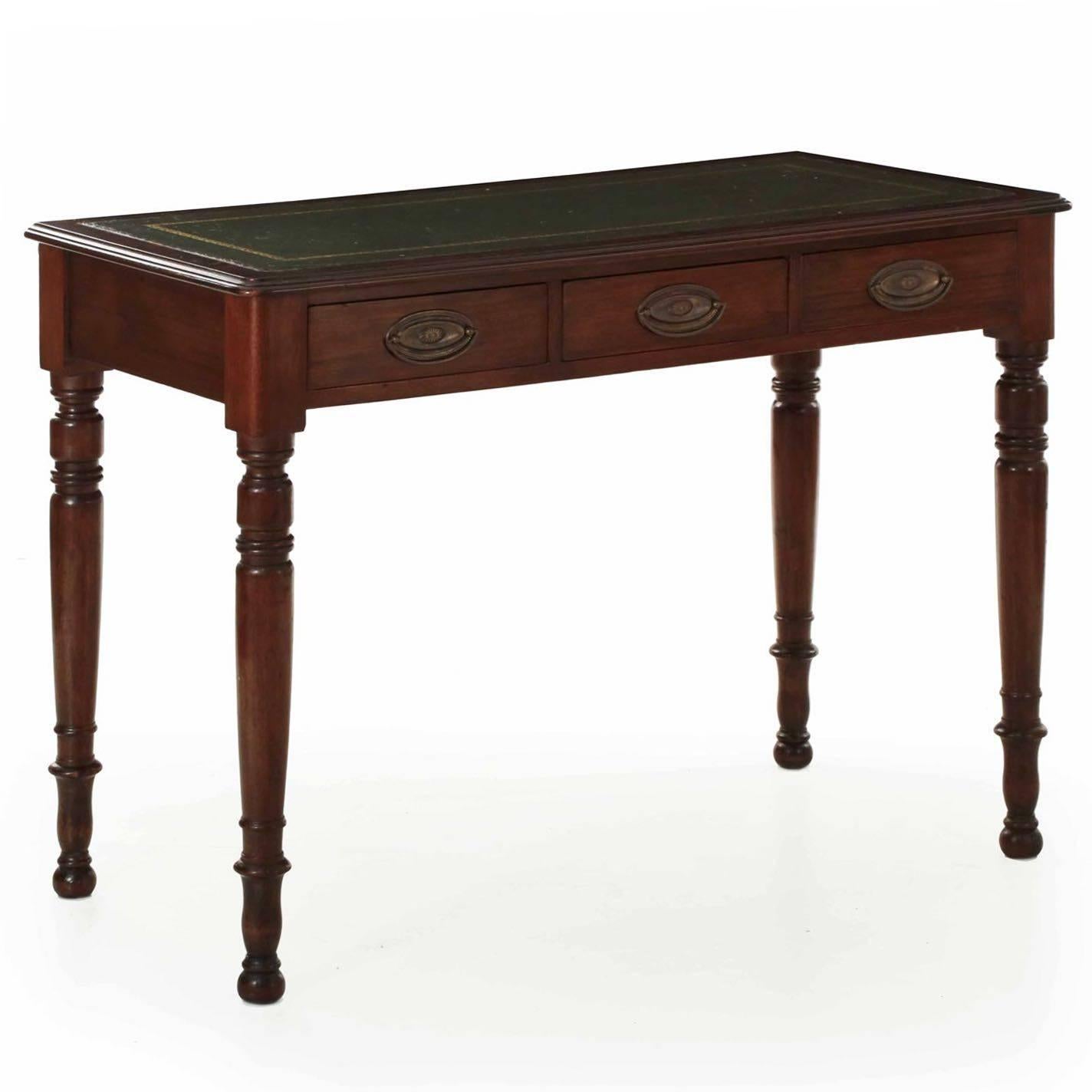 A very nice writing table in the Regency style from the last quarter of the 19th century, this orderly little piece is quite tasteful in it’s dimensions and most attractive in surface patina. The old aged mahogany has beautifully worn and burnished