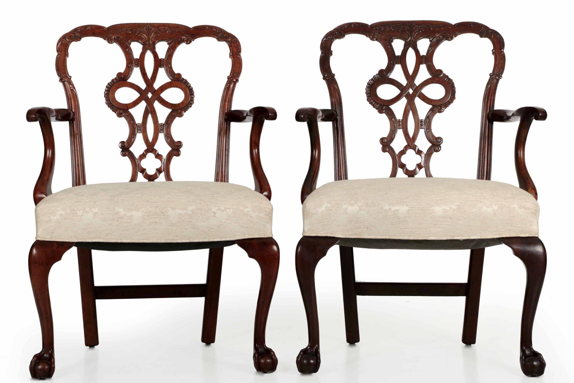 A very finely carved set of ten dining chairs in the Chippendale taste, they are crafted of a dense and beautifully figured mahogany with very fine craftsmanship throughout. The pierced splats exhibit the distinctive Rococo motif borrowed from the