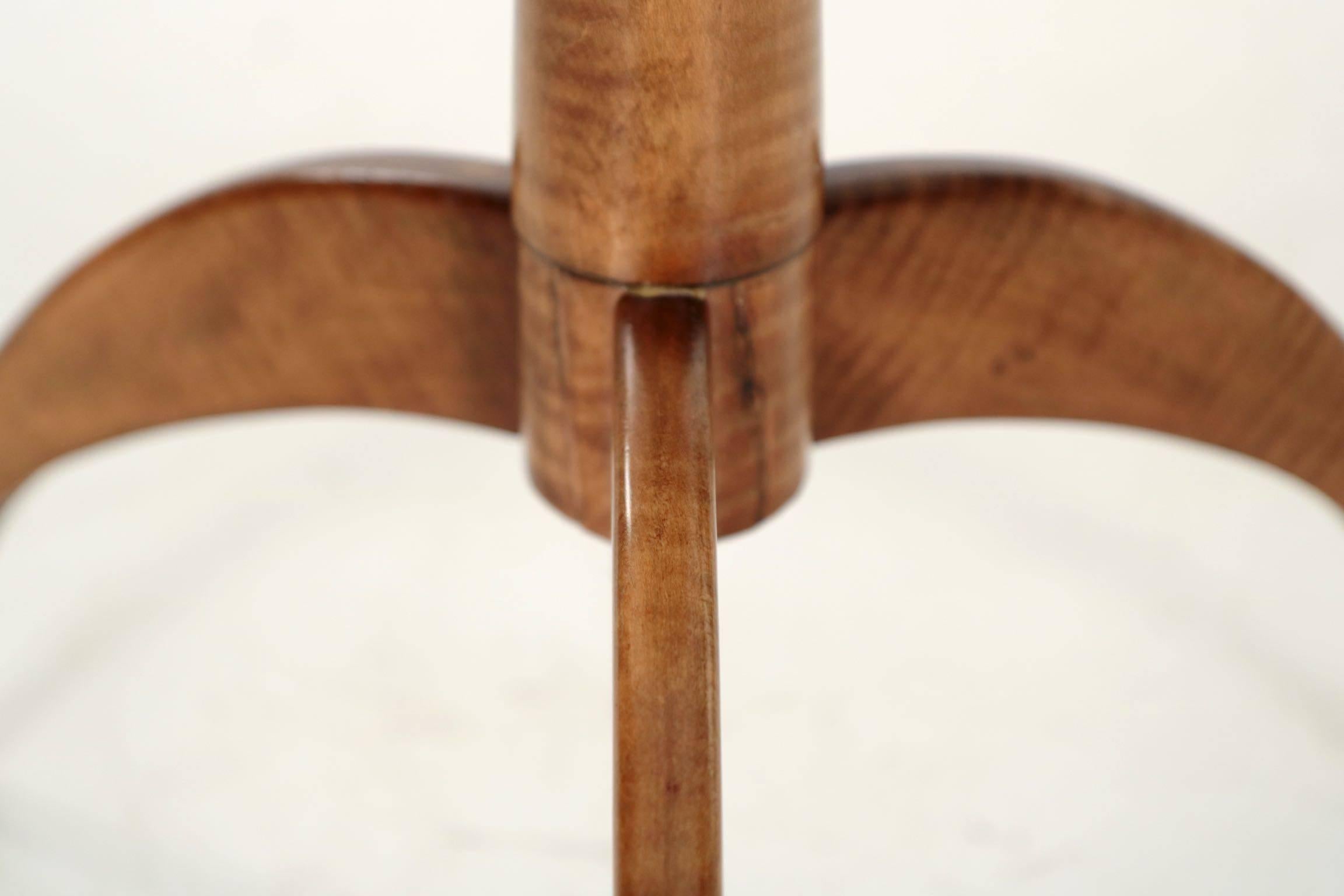 This very sleek and finely crafted solid cherry candle stand is austere and designed with simple effective lines. The round top is chamfered around the edges to lighten the visual weight of the top, allowing the thin edge to float over the tapered