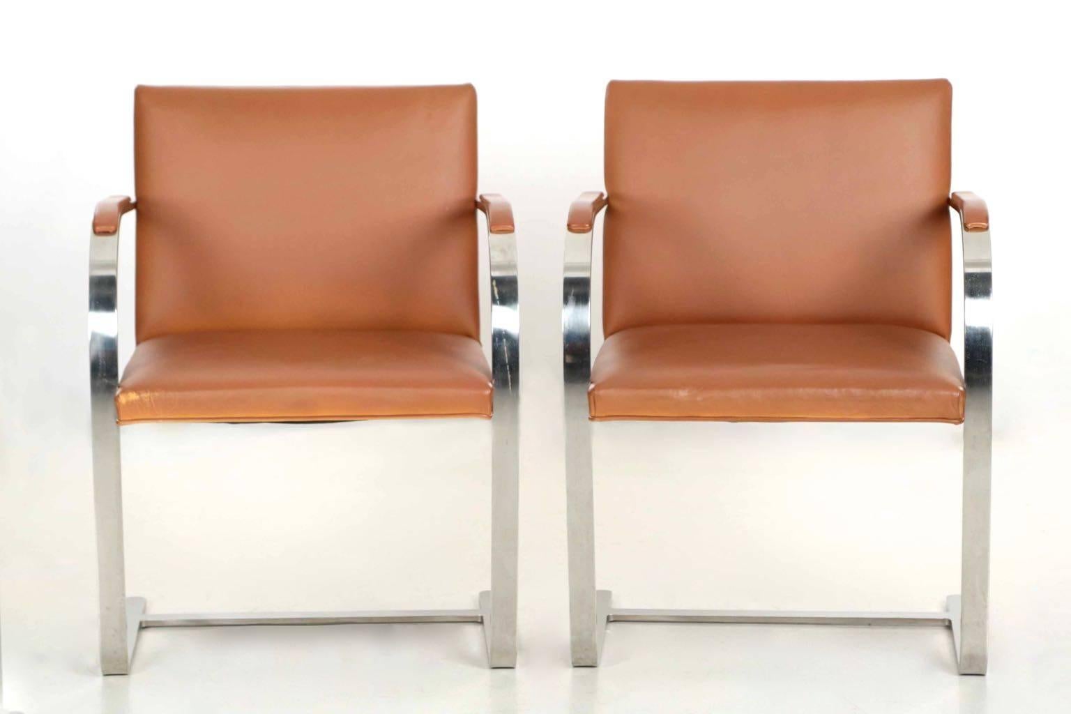Typical of Knoll, the machining on this pair of chairs is exquisite with perfect welds and flawless finishing of the metal. The iconic Brno flat bar arm chair was designed by Ludwig Mies van der Rohe and the present pair were manufactured by Knoll
