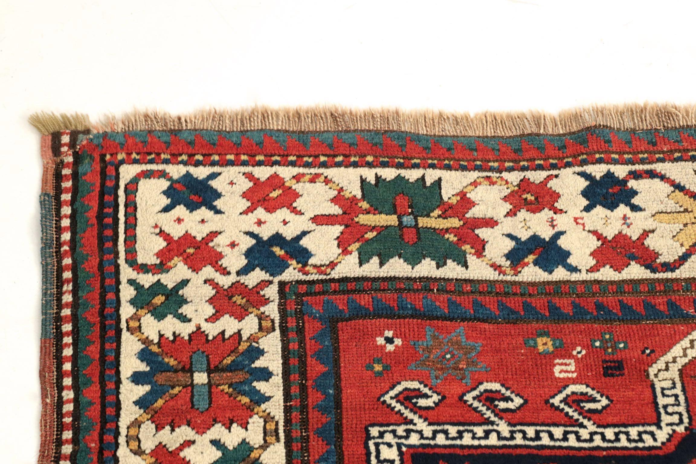 These colorful and vibrant rugs originate in the valleys of Georgia, Armenia and Azerbaijan in the Caucasus. This example was woven circa 1900 with a wealth of motif and bold vegetable dyes. The main border is a powerful display of the repeating and