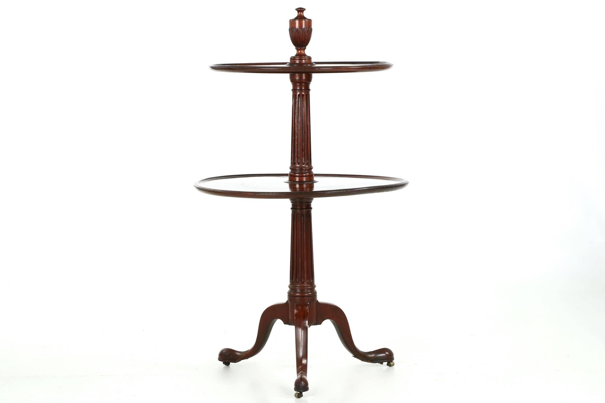 A finely designed and executed dumbwaiter table, this example is particularly nice with it’s crisply carved waterleaf urn-finial on the top level. Perfectly formed from a solid block of mahogany, the urn elevates the table above it’s peers