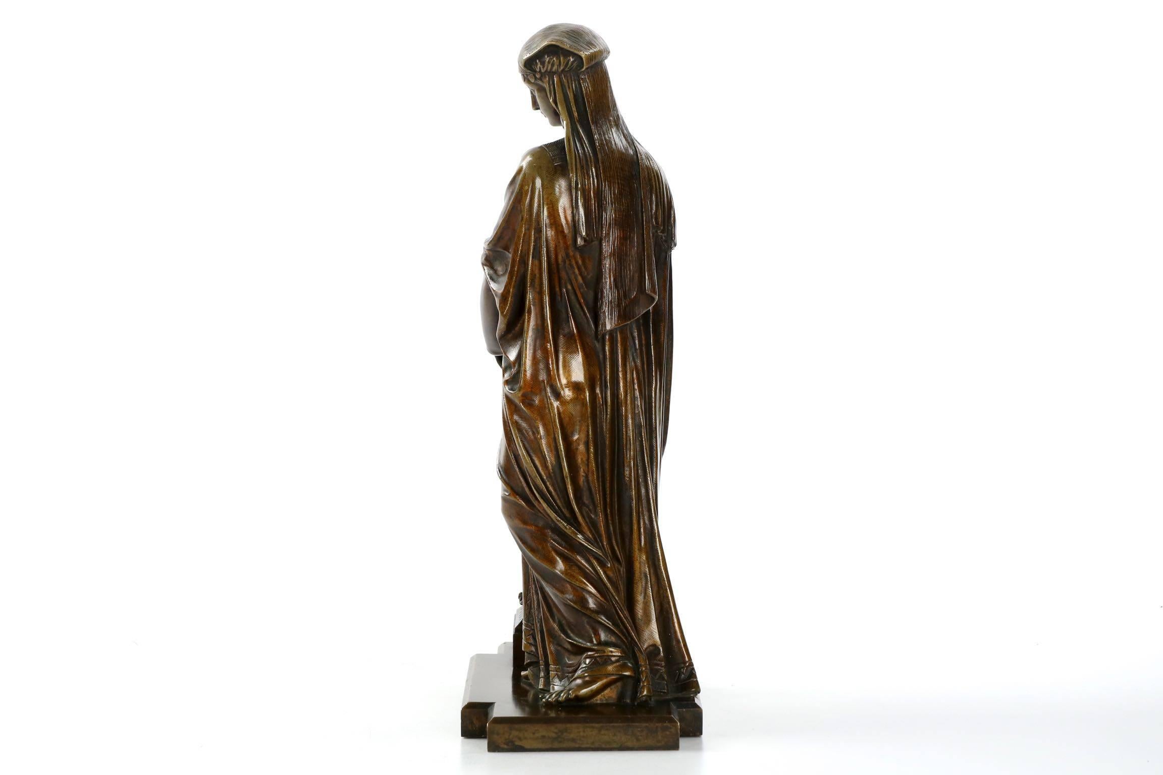 The standing female is lost in thought as she pauses, leaning on the vase she has resting on a plinth, perhaps waiting for a chance to fill her vase with water from the well. An exquisitely cast work by an unknown sculptor of the period, her dress