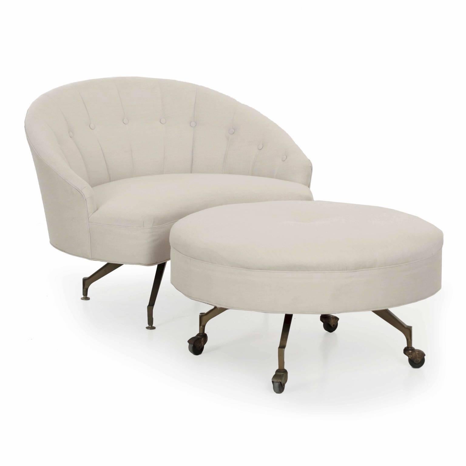 A striking vintage chaise lounge with a roll-away ottoman, the chair is beautifully tufted with a neutral woven linen fabric, both the ottoman and chair deeply stuffed for comfort and support. The chair rests over angle-iron legs, the ottoman with