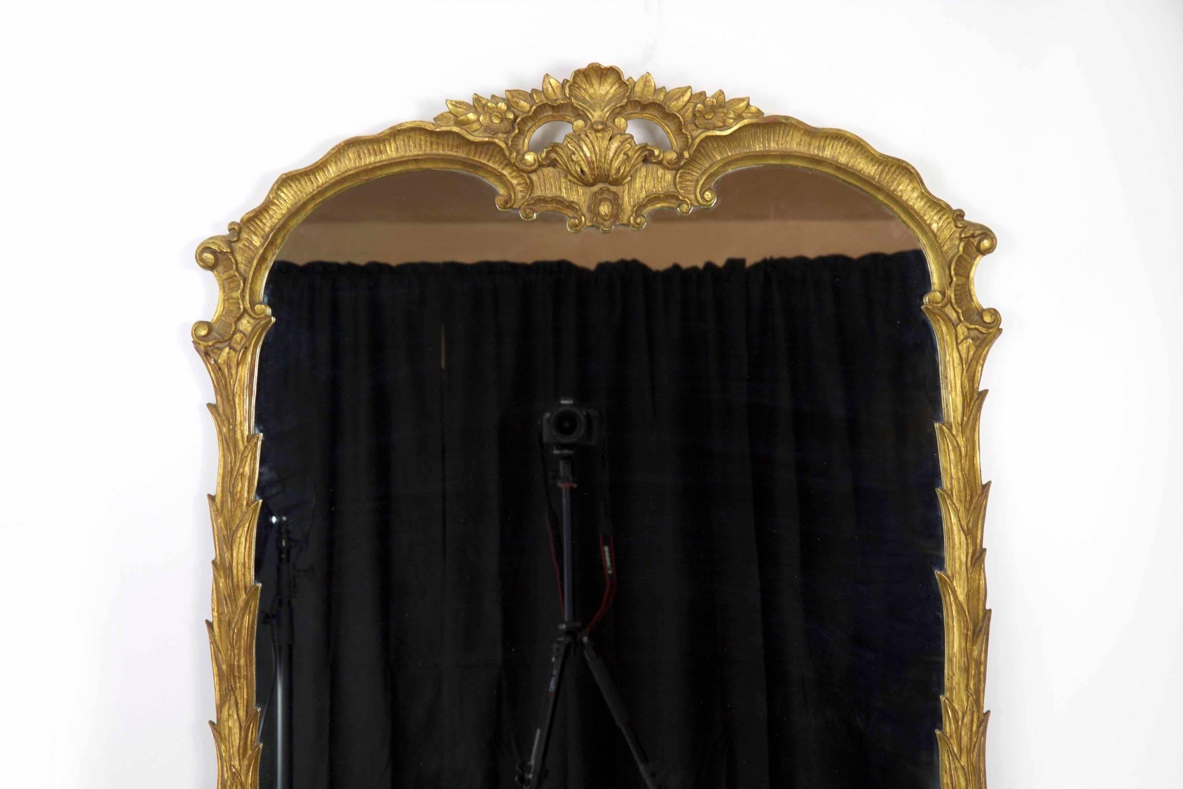 The refreshingly organic interpretation of the Rococo motif found in this finely crafted mirror is unusually striking. It has a degree of restraint where the undulating shape allows the chaotic display of waterleaves that furl and climb the frame to