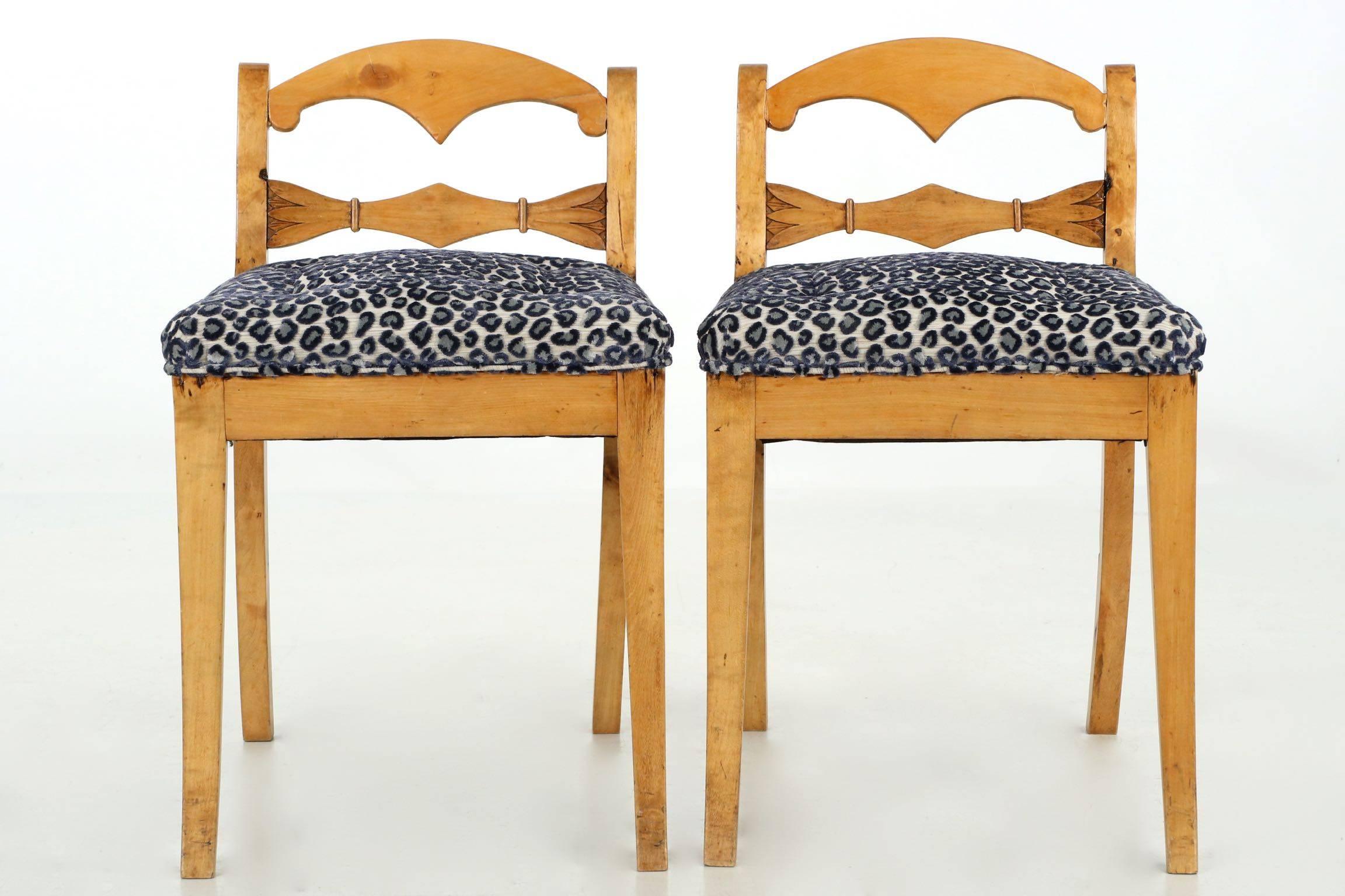 A pair of refined side chairs done in gorgeous honey colored fruitwood, and although they were created in the late 19th century have a highly modern elemental aesthetic. Not a bit overdone in any of its lines or proportions, it sits in