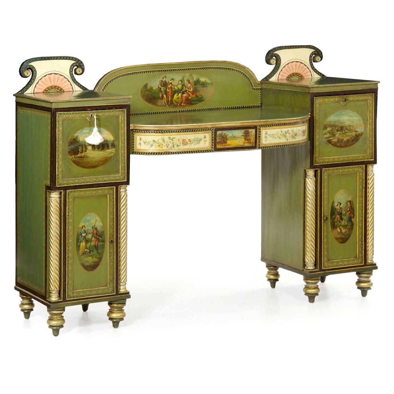 A striking pedestal sideboard with an overall green ground polychrome surface against gilded highlights, the sideboard is knock-down for easy and safe transport. The arched backdrop is enhanced with a large classical genre scene of figures