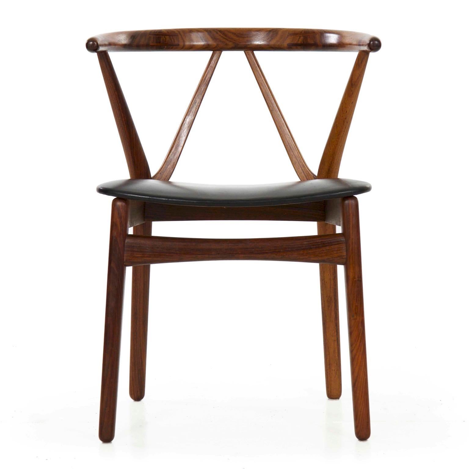 Danish rosewood hoop back armchair by Kjaernulf for Hansen
Model 255; Bruno Hansen stamp to underside, Denmark, circa 1950s.

A very finely made chair designed by Henning Kjaernulf for retail by Bruno Hansen, the frame is carved from rosewood