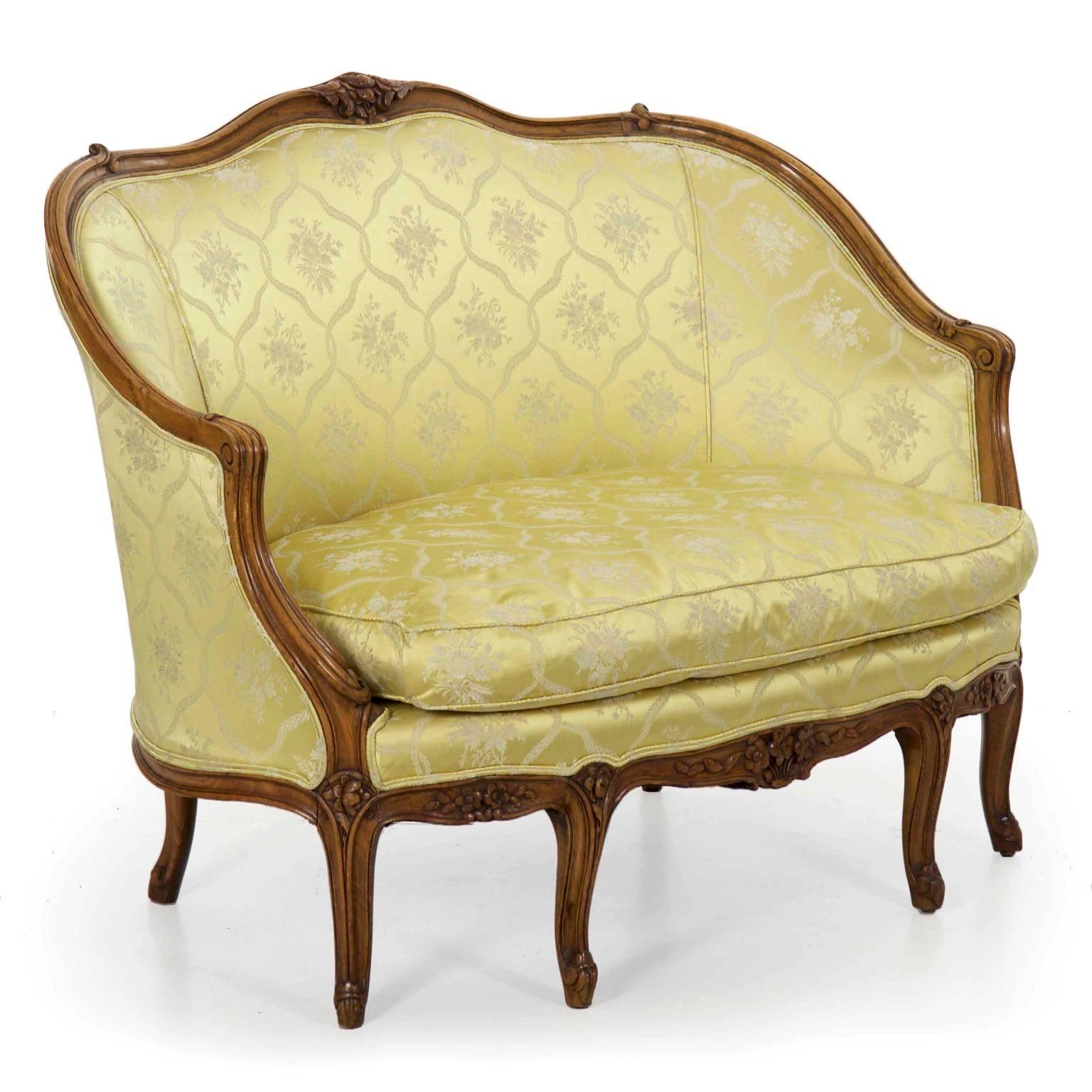 We love this gorgeous little antique French canapé sofa with its slight proportions and relentless curvatures. It moves beyond the typical carvings of the era and introduces nearly unique carved motifs in the feet, transforming the typically
