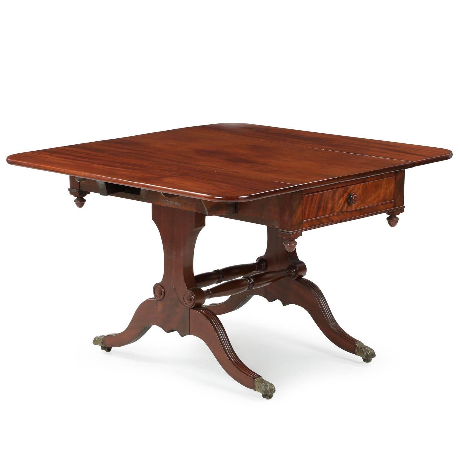 A simply gorgeous work with untouched structure and originality other than an early surface refinishing, this fine American Classical breakfast table is a statement of lasting quality and richness of surface. The vibrant mahogany grains of the top