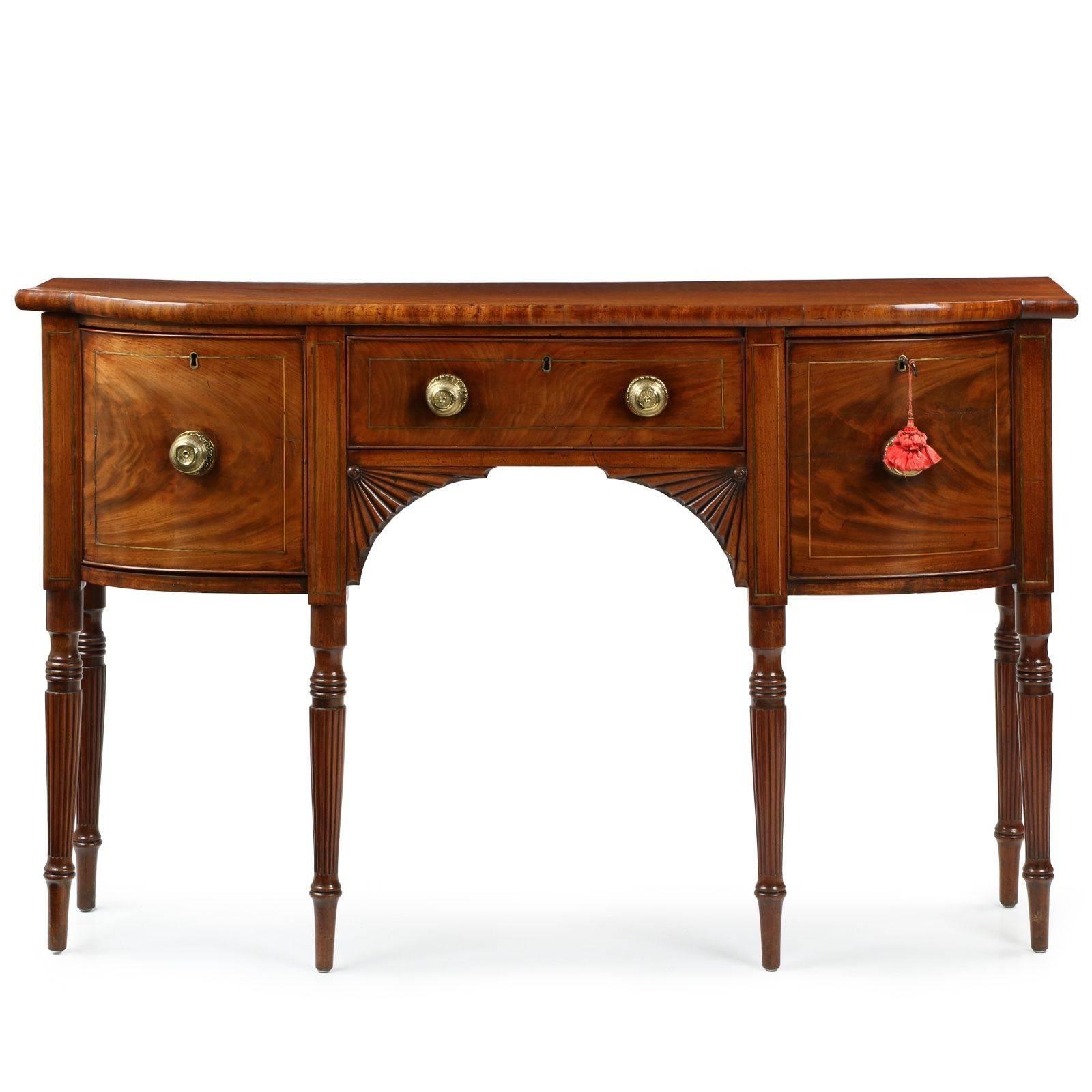 A piece that is inordinately beautiful in every way, refined and balanced with a wonderfully mellowed patination throughout, this very fine Regency sideboard is a rare and precious find.  Of petite and very desirable dimensions, being only 15 7/8