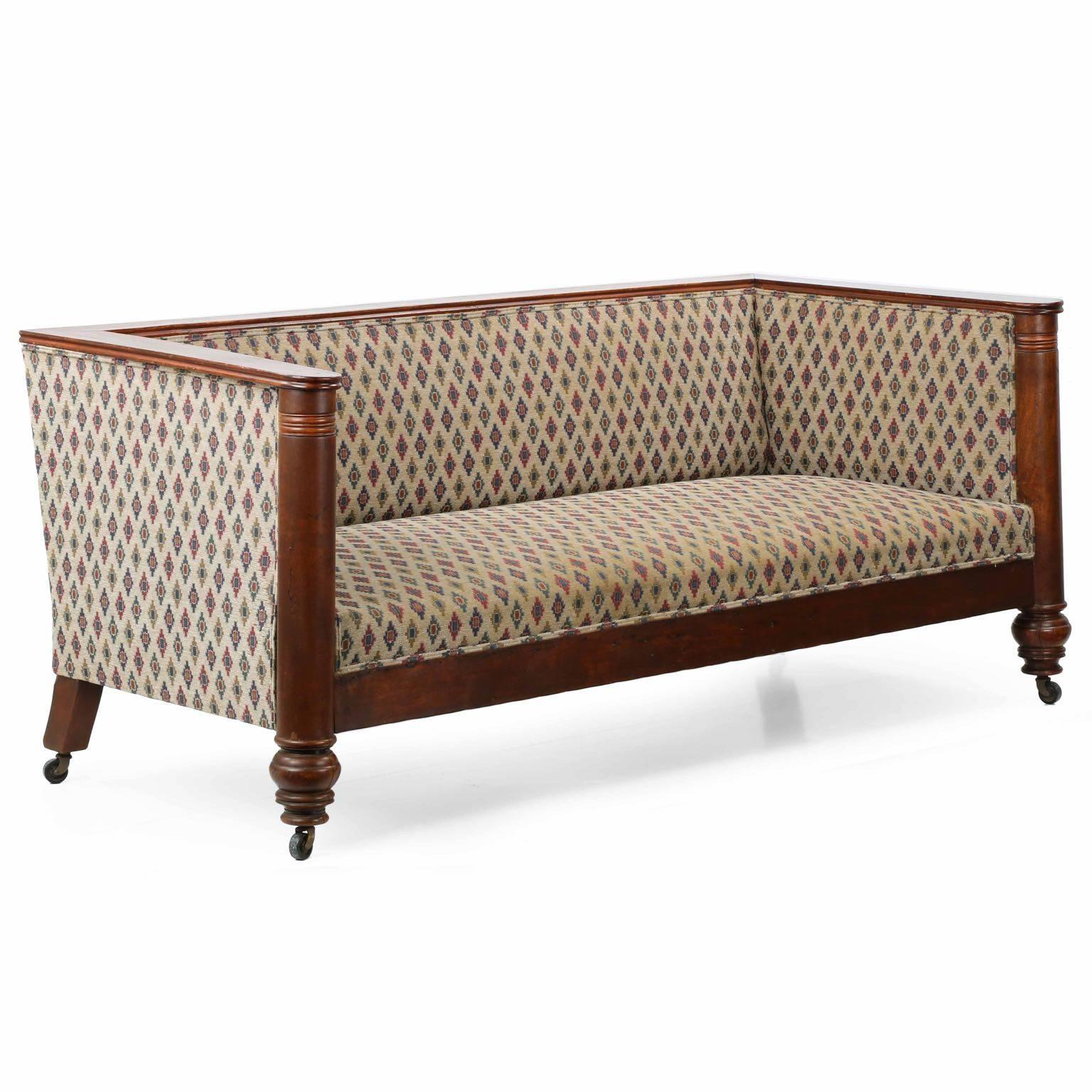 A very interesting form, striking and angular, this Empire box-form sofa is an interesting display of bold proportions and materials so commonly associated with the period.  Crafted during the last quarter of the 19th century, probably in America