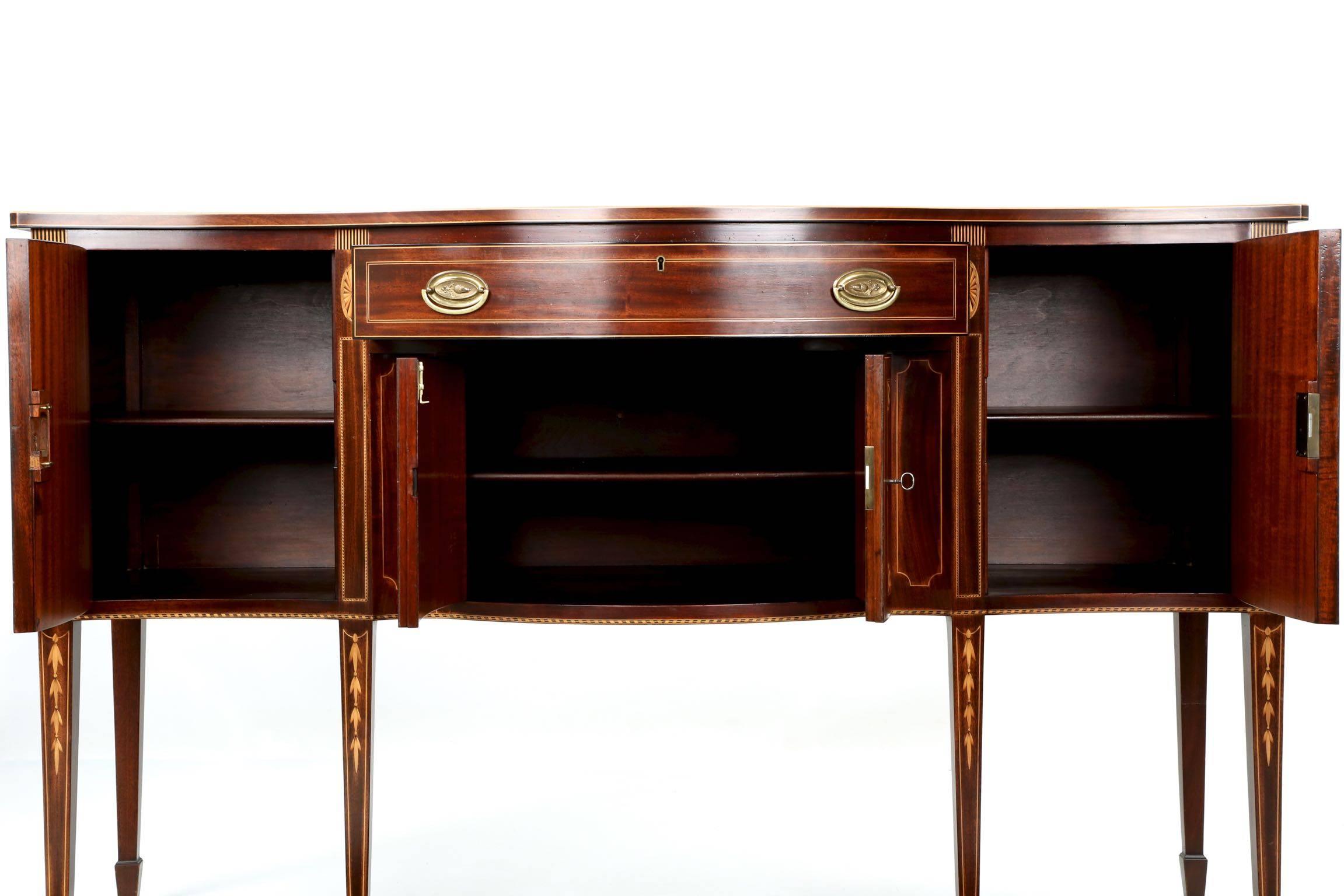 A fine handcrafted reproduction from the one of the most well respected and prolific firms of the first half of the 20th Century, this sideboard is an excellent representation of what they were capable of producing.  The beautiful solid mahogany and