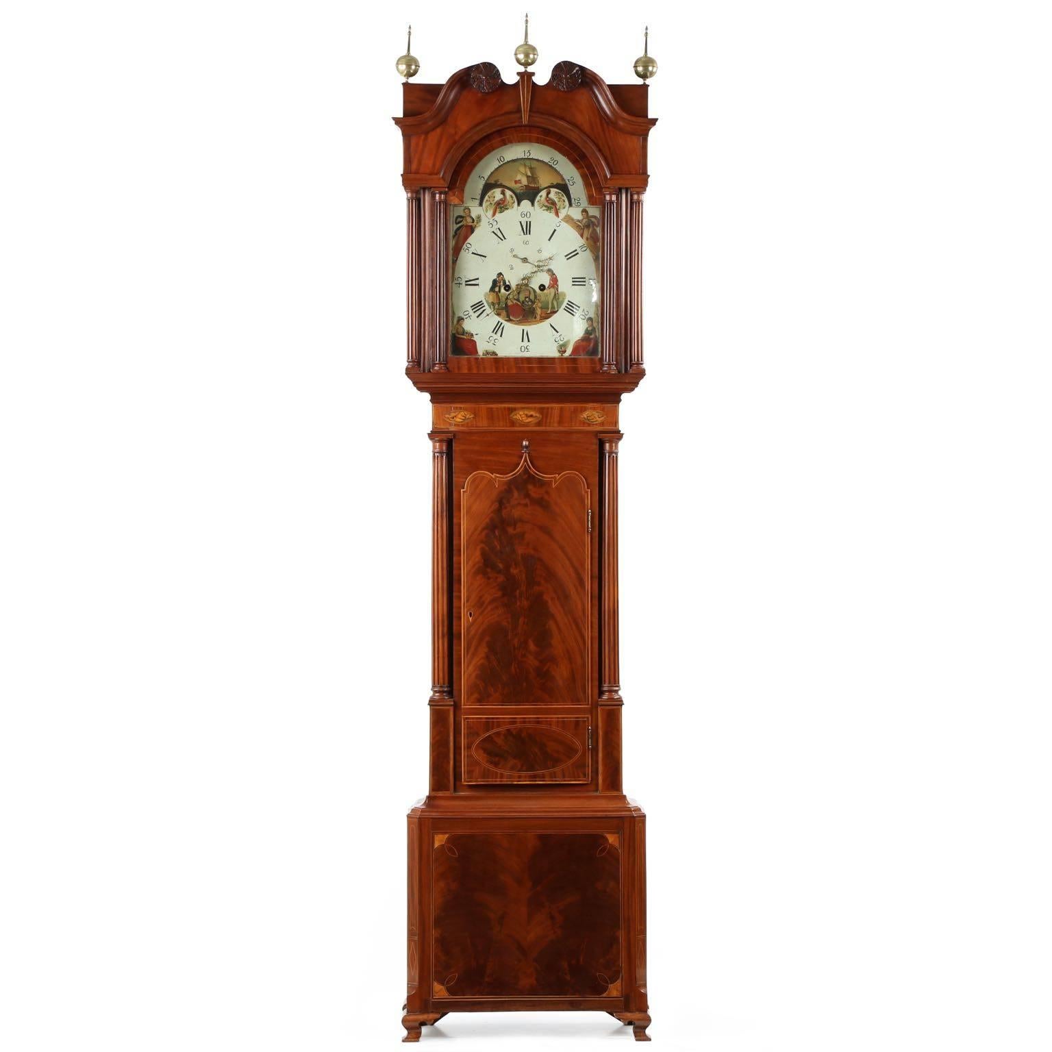 An intricately detailed work, this fine English Georgian tall case clock crafted during the first years of the 19th Century is distinguished by it's extensive satinwood stringer inlays - a work strongly influenced by the Neoclassicism of the period,