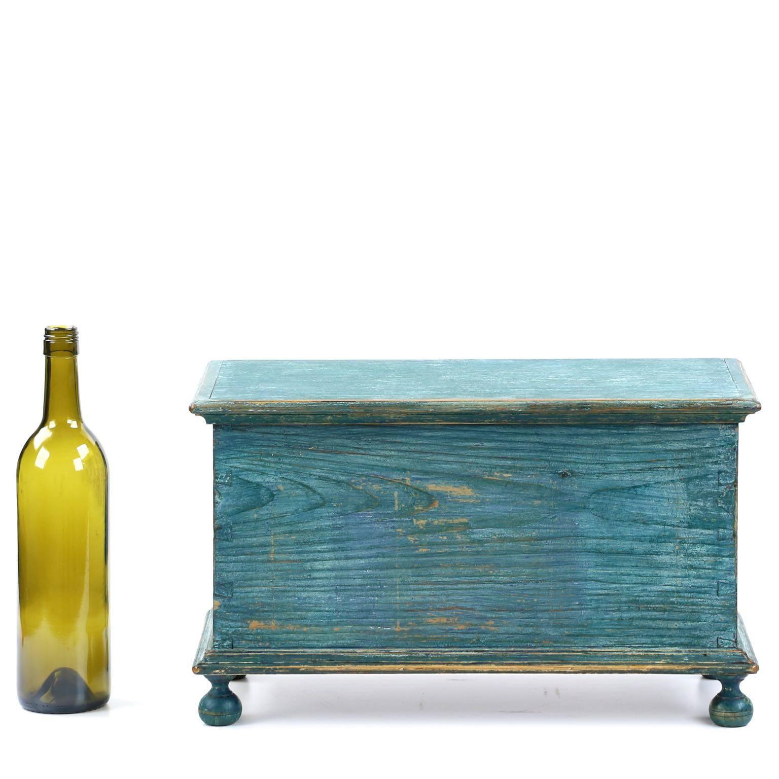 An absolutely stunning and entirely original miniature chest, this precious piece retains a very early and vibrant blue painted surface and is untouched other than replaced brass hinges and remnants of later paint.  Clearly a work of Southeastern