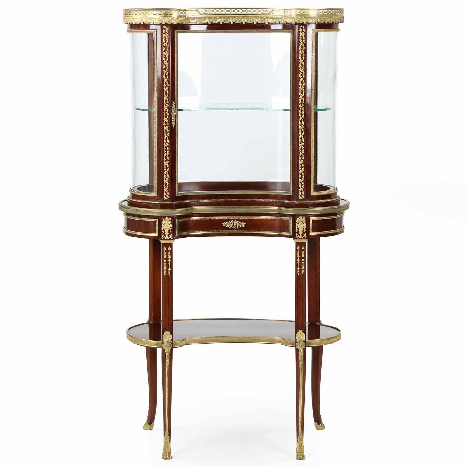 A work of incredible discipline and demanding attention to detail, this inordinately fine vitrine of the Bell Epoque is a statement piece in every way. Deep pure grain mahogany primary surfaces retain their brilliant ruby hues under a French polish,