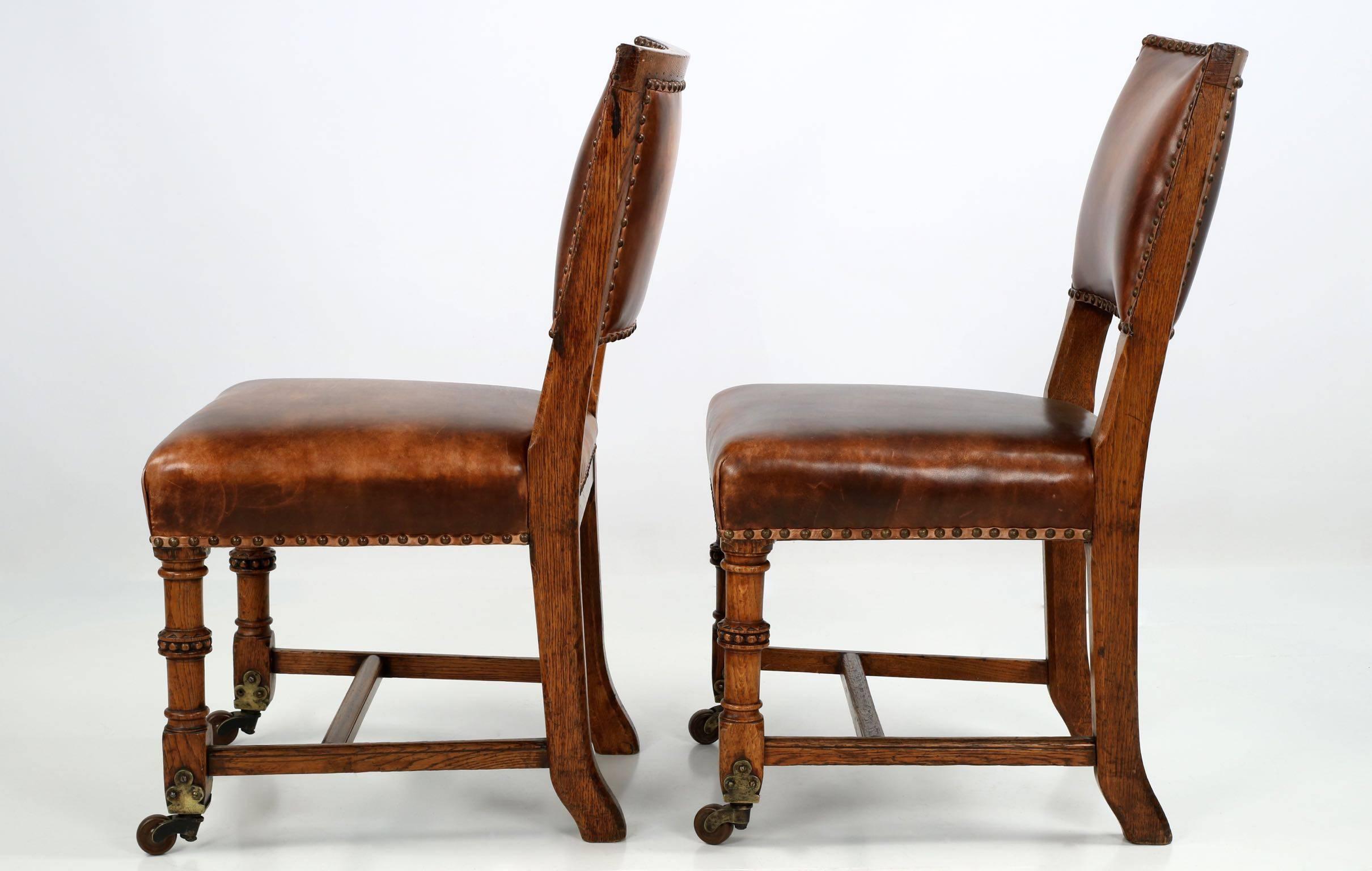 Arts and Crafts Pair of English Antique Leather and Carved Oak Side Chairs, circa 1900