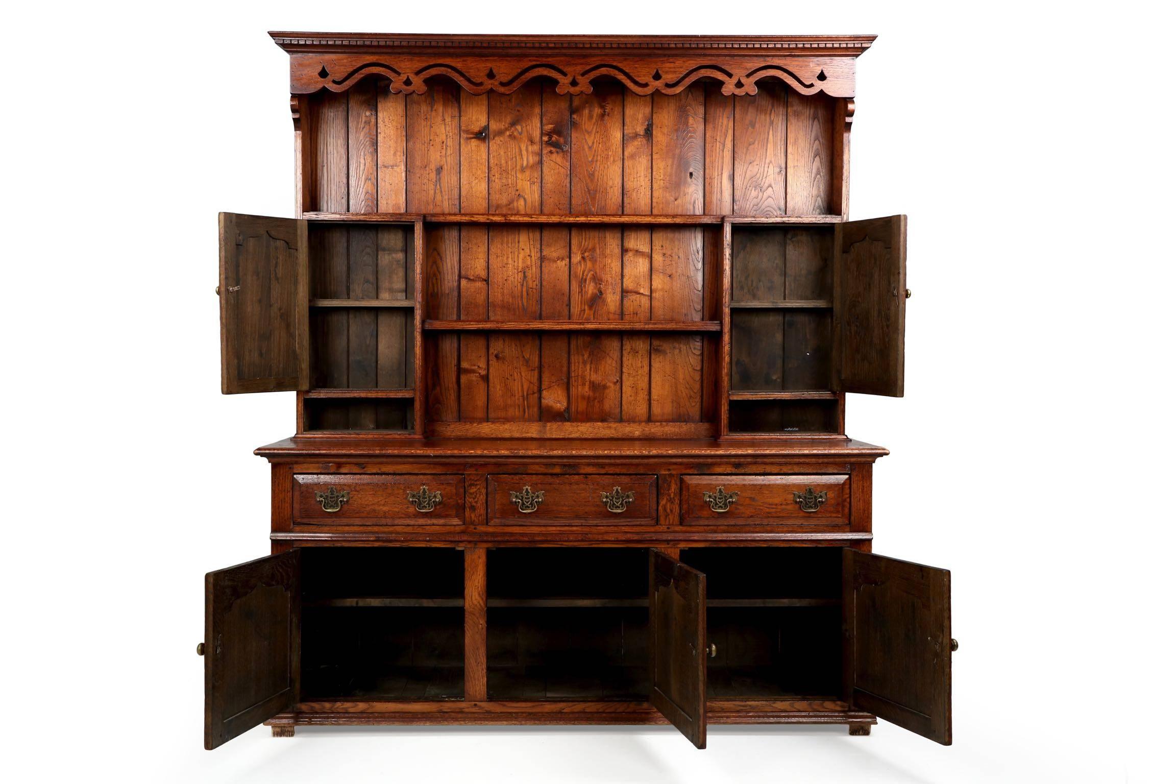 A finely hand crafted piece, this English Welsh Cupboard was entirely bench made during the first quarter of the 20th Century. There is a well developed patina to the oak oak, being silky to the touch from years of waxing and gentle wear; the