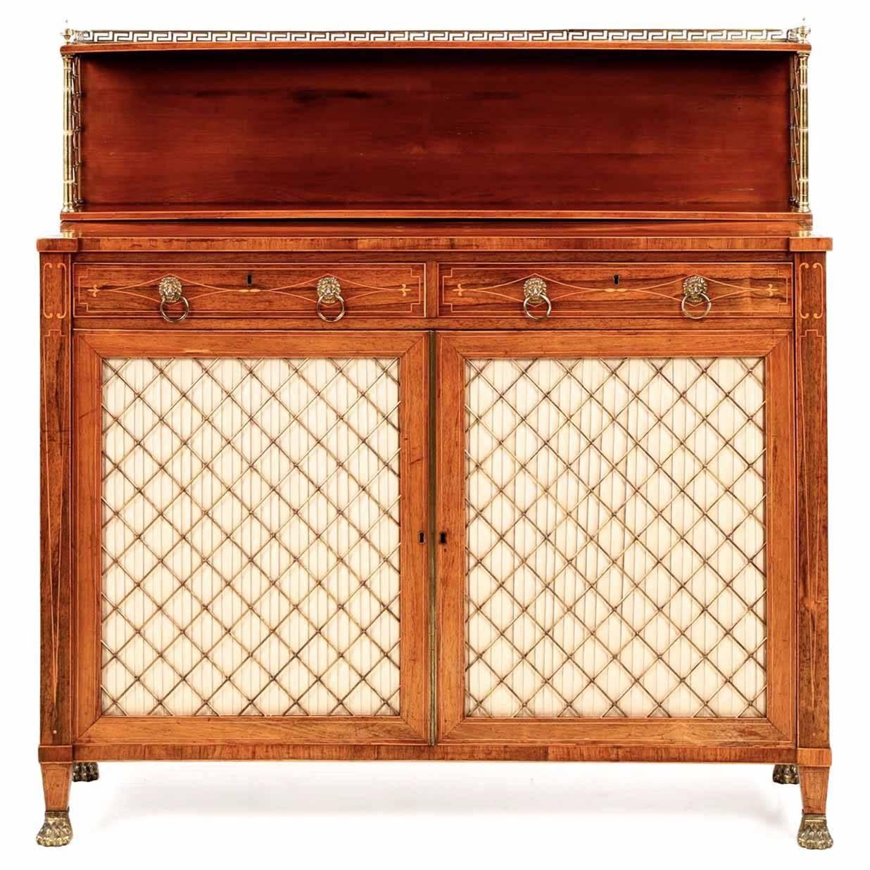 Of precise and exquisite craftsmanship, this inordinately fine chiffonier is finished in gorgeous mellowed rosewood veneers. Intricate displays of brass work and scrolling satinwood stringer inlays flow across the top of the case, the border a