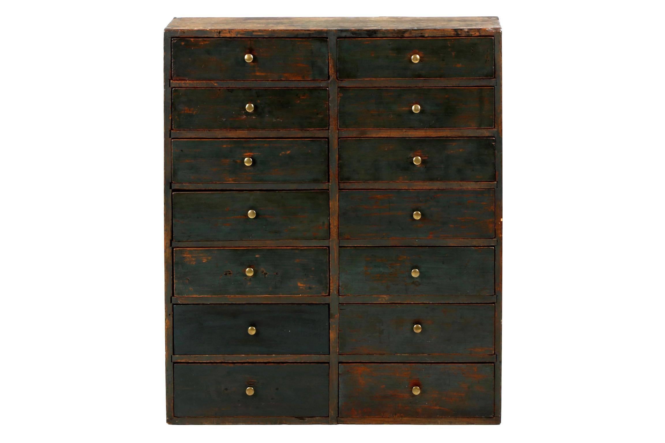 Preserved in lovely condition, this early 19th century apothecary cabinet is austere and angular, a form of clean lines and orderly construction. Dominated by dovetail joinery, the four sides are locked together with large exposed dovetails; the