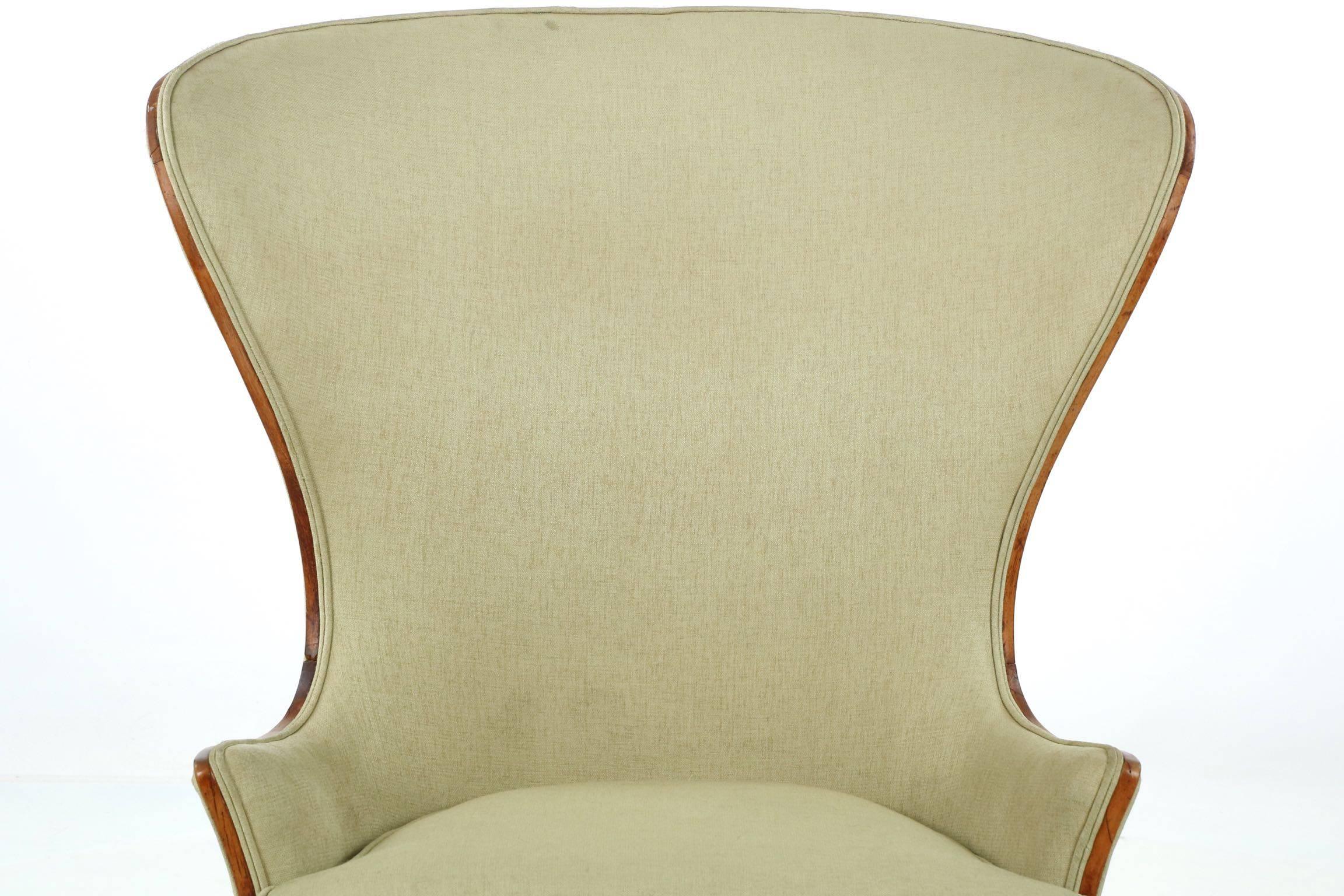 This is a chair that is well ahead of it’s time, the bold and incredibly powerful curvature of the back more reminiscent of the Danish designs of the Mid-Century than a work of art from the late 19th century. A tasteful woven green upholstery lends