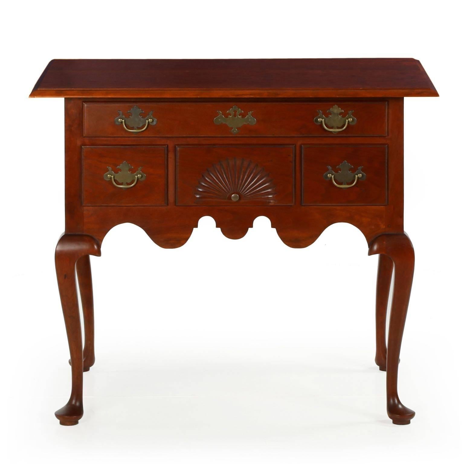 A very nice handcrafted reproduction of the original lowboys from Connecticut, circa 1760, this entirely bench made piece was crafted by the firm of Eldred Wheeler and retains original labels in the drawers. The piece is crafted of solid cherry, the