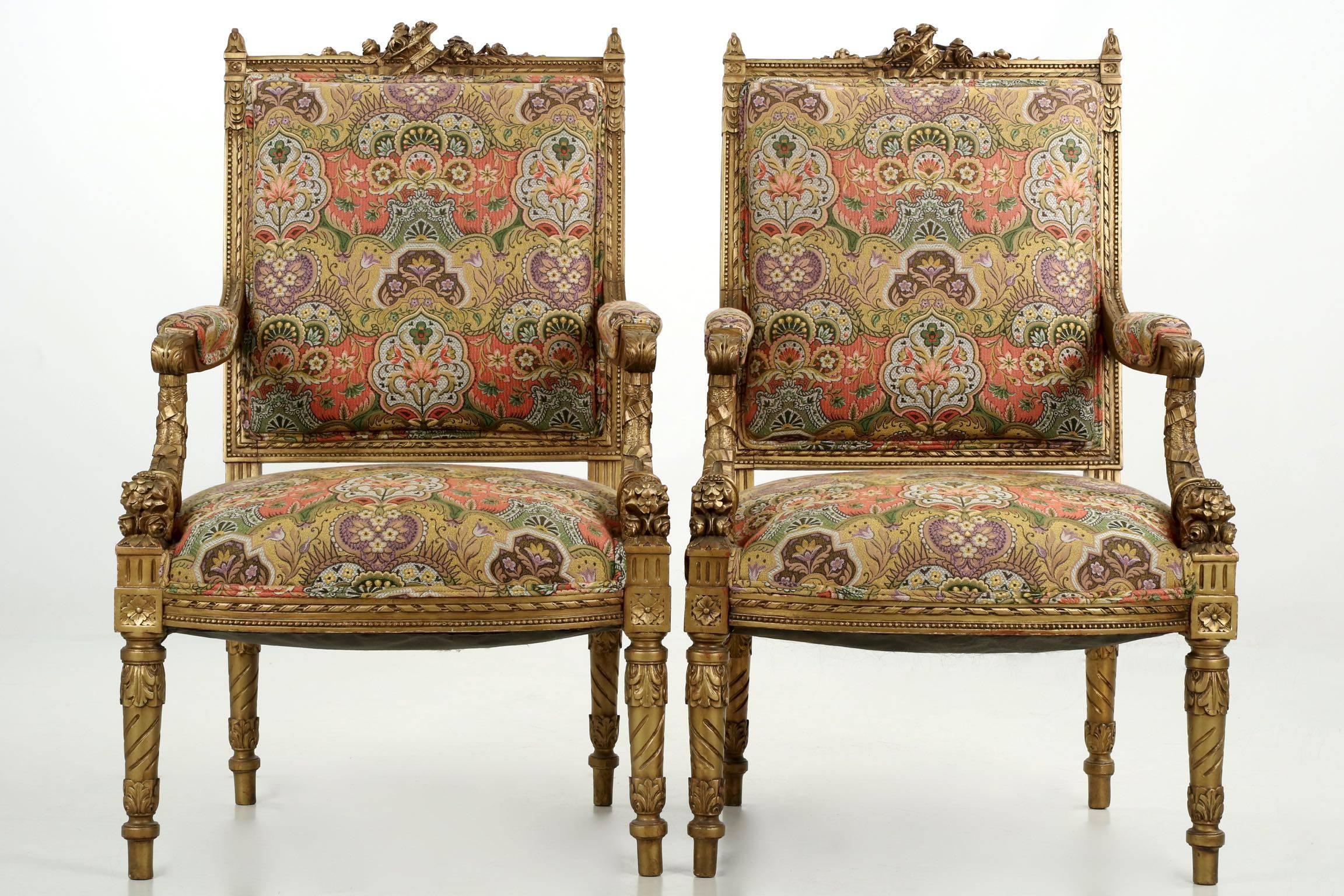 A richly embellished salon suite comprised of a settee and two matching arm chairs from the second quarter of the twentieth century, the detailed and complex surface carvings are quite nicely executed throughout. The pierced floral displays on the