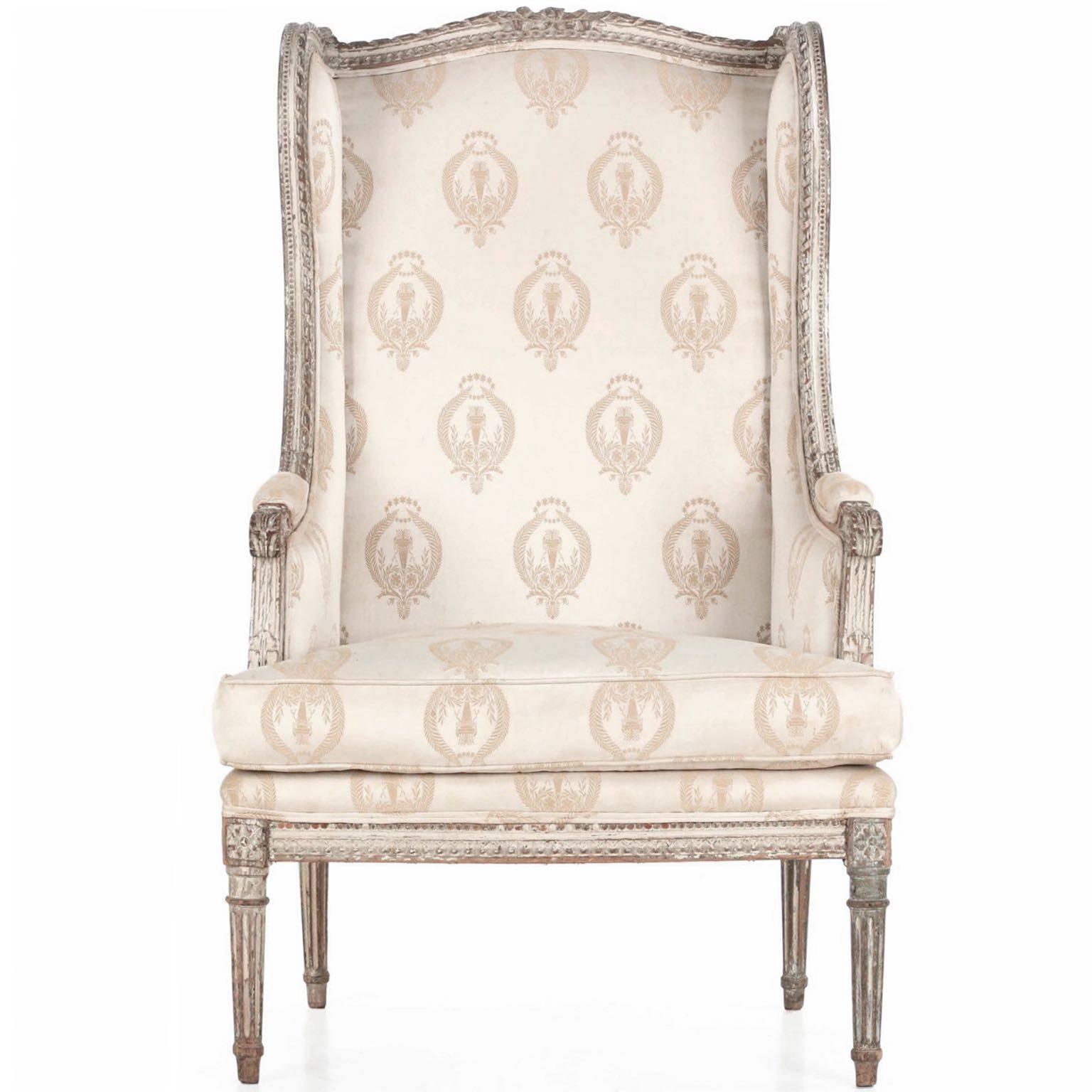 This delightfully worn chair of the Louis XVI taste has such beauty in the numerous layers of scrubbed cream, white and gray paint; the carvings are crisp in recesses and naturally softened in areas of greatest handling. Built to last the test of