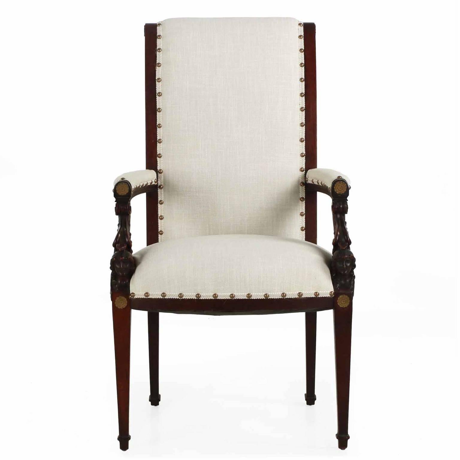 An incredibly striking armchair from the third quarter of the 19th century, this gorgeous piece is carved with inordinate care from huge solid blocks of mahogany to form the crisp helmeted and winged figures flanking either side of the seat. The