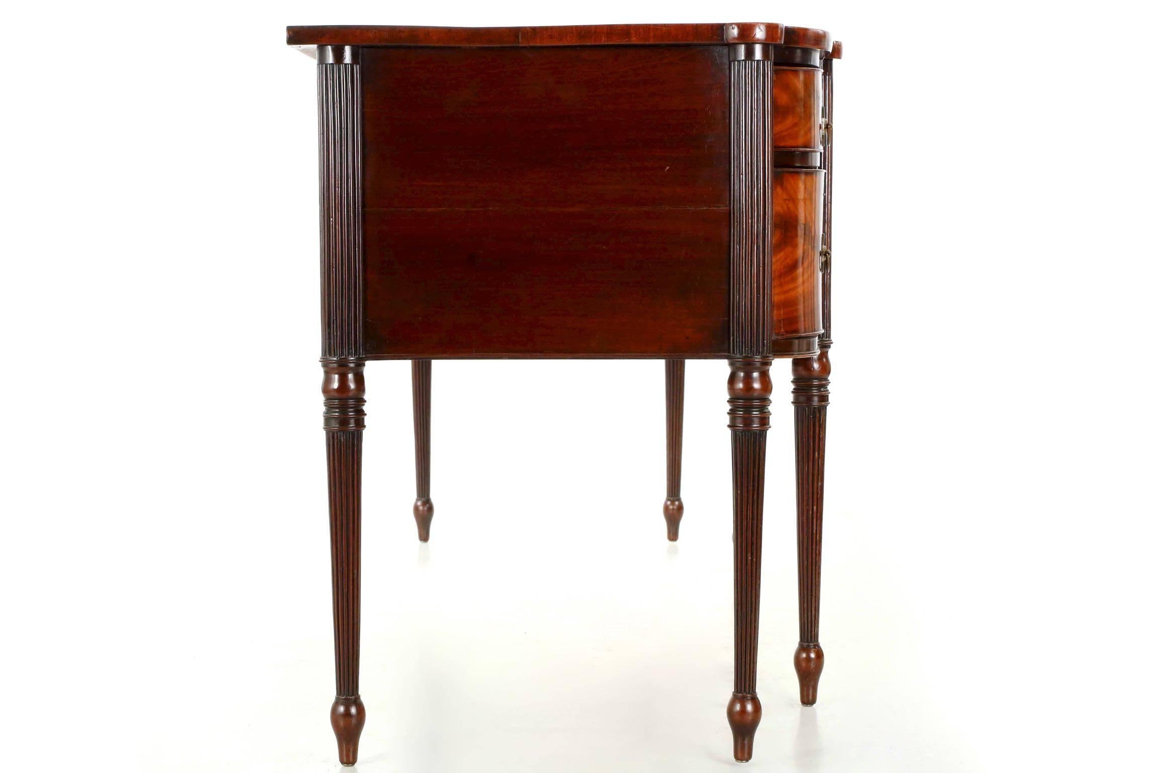 A most spectacular piece of early American craftsmanship, this very fine sideboard is closely related in form to works from the North Shore of Massachusetts and the Seymour school. It’s unusual length is particularly noteworthy, measuring a full 92