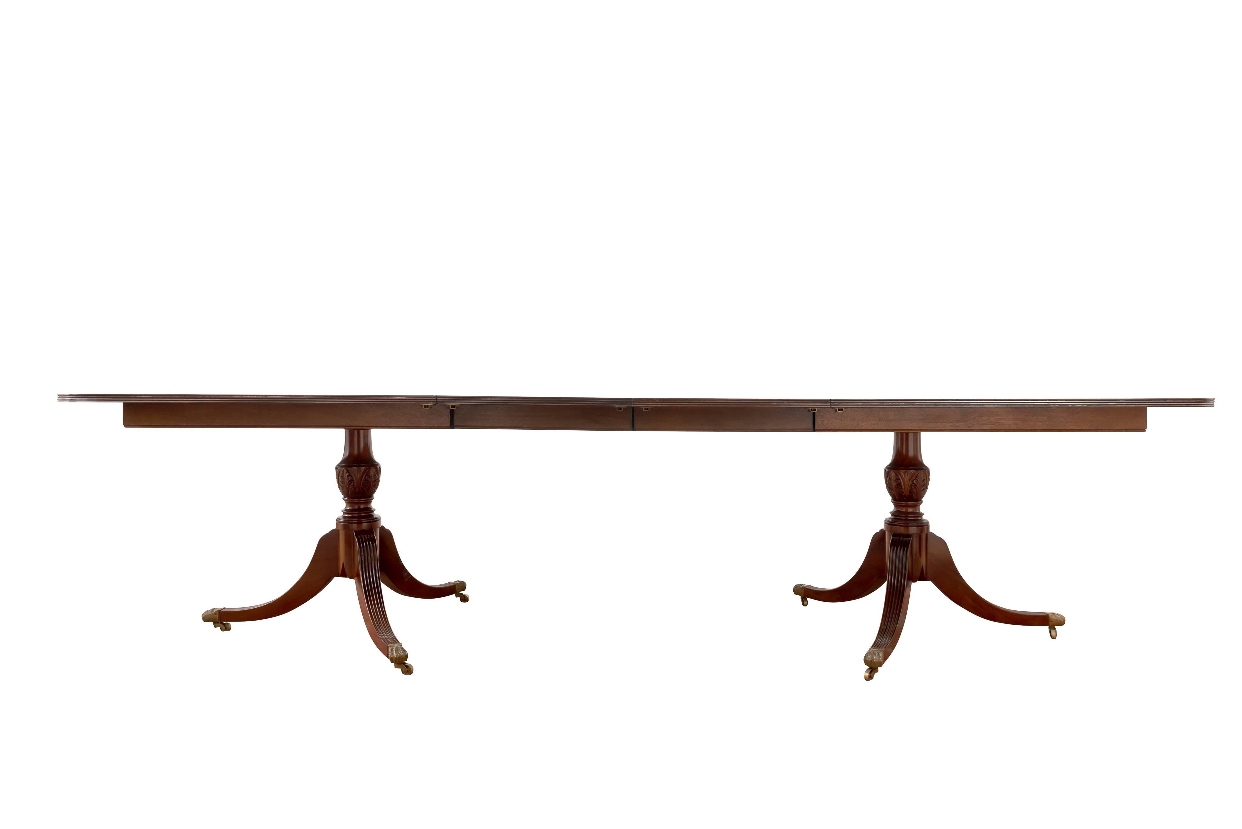 Sheraton style mahogany double pedestal table with D ends. It has triple crossbanding of satinwood and walnut around the table top. The table has a reeded edge. 
The table is 48