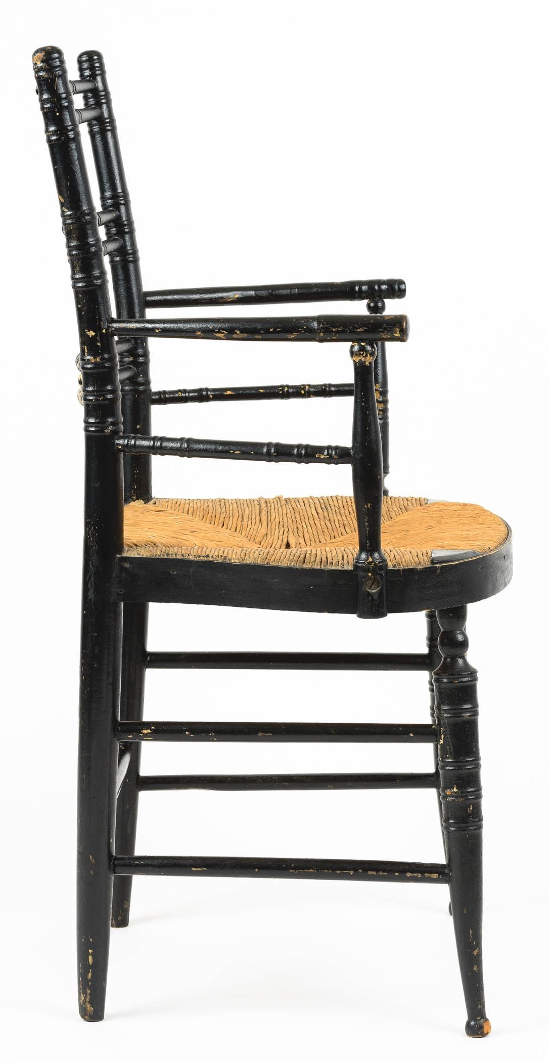 The late Sheraton chair has ball and turned detail on back as well as the front stretcher. The turned arms are slightly bowed joining the back and off set from the bending of the front of the seat. The legs has ring detailing as does the arms and