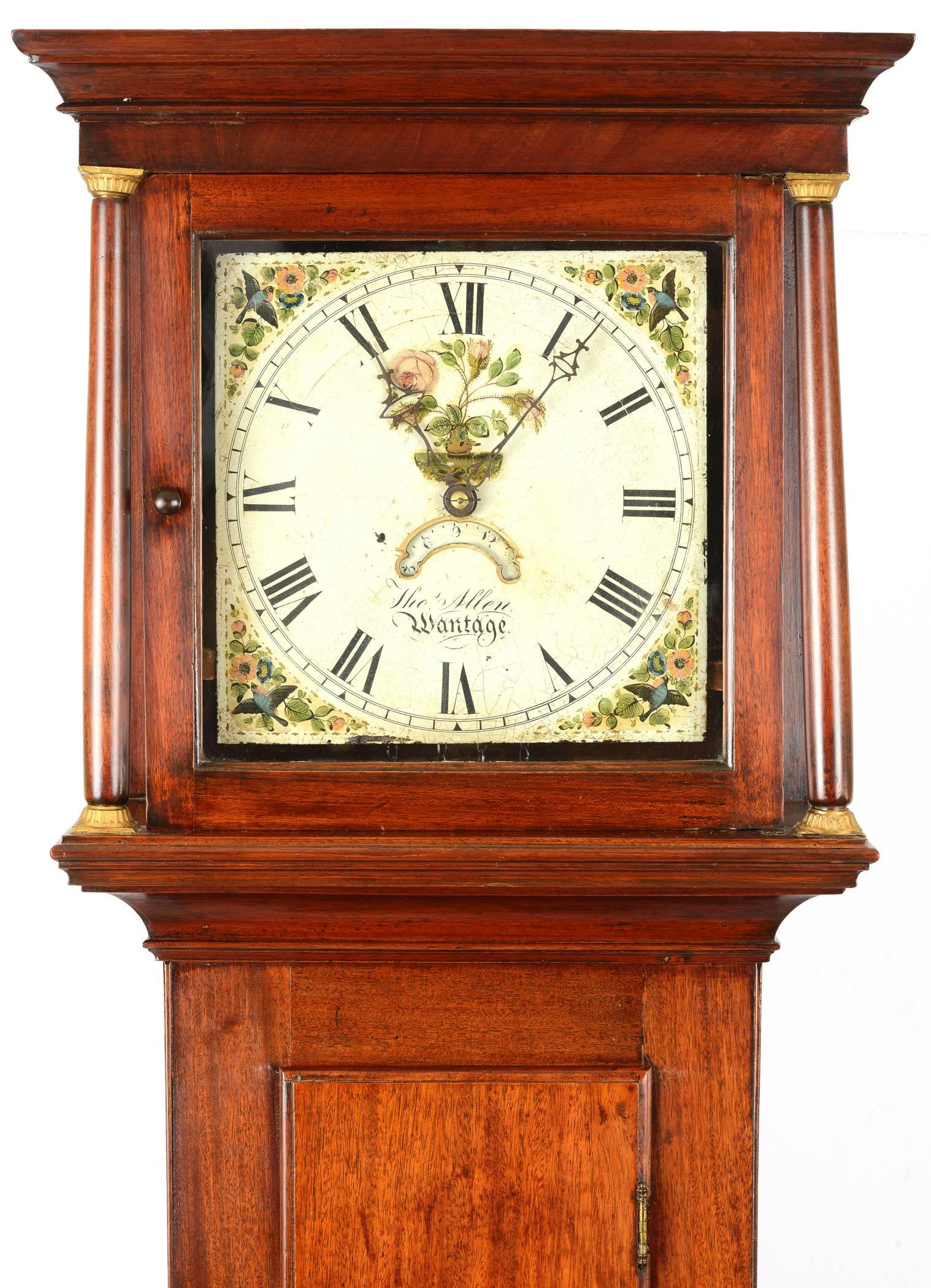 Late 18th century mahogany tall case clock of charming proportions. The clock is signed Thomas Allen, Wantage (England). The metal clockface has urn of flowers and the flower detail is repeated in the corners of the face. It has a calendar aperture.