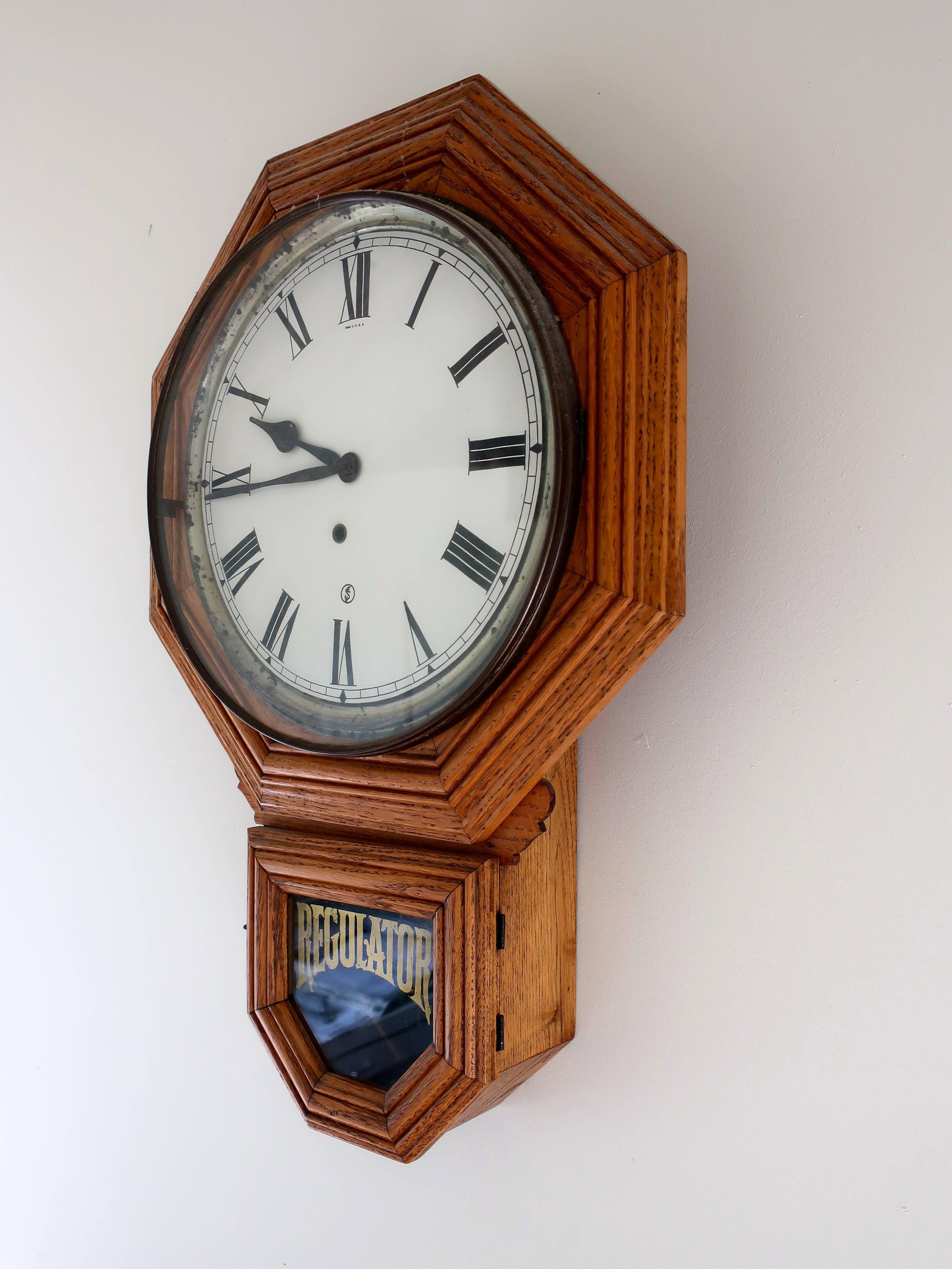 Vintage oak wall clock by Regulator, made in the USA. The clock is complete and has the original finish and clock key.