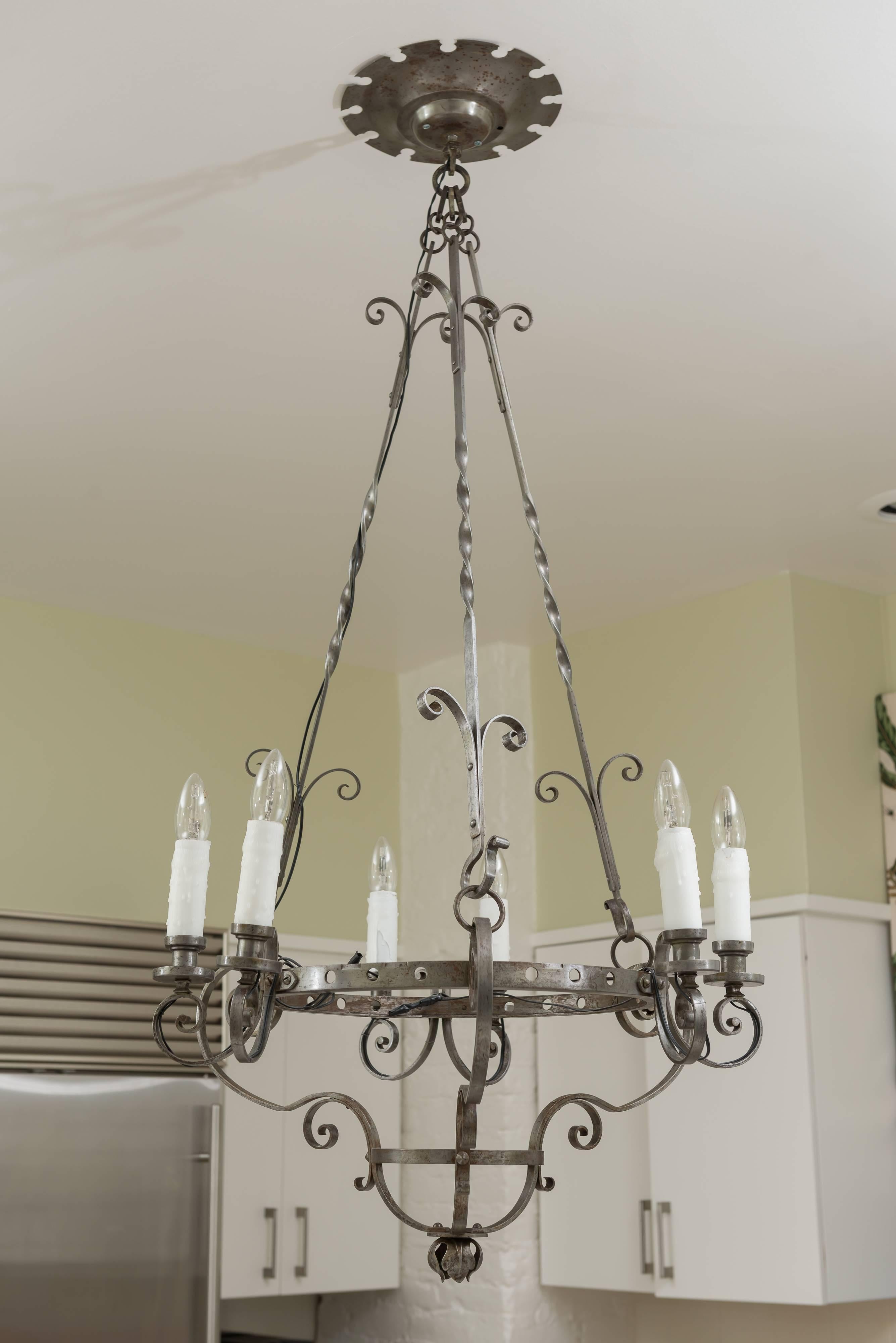 Gunmetal six-light chandelier with curves, curls and rose detail. The chandelier is suspended with three twist rods. The ceiling rosette is has cut detail. The chandelier is newly wired for US use.