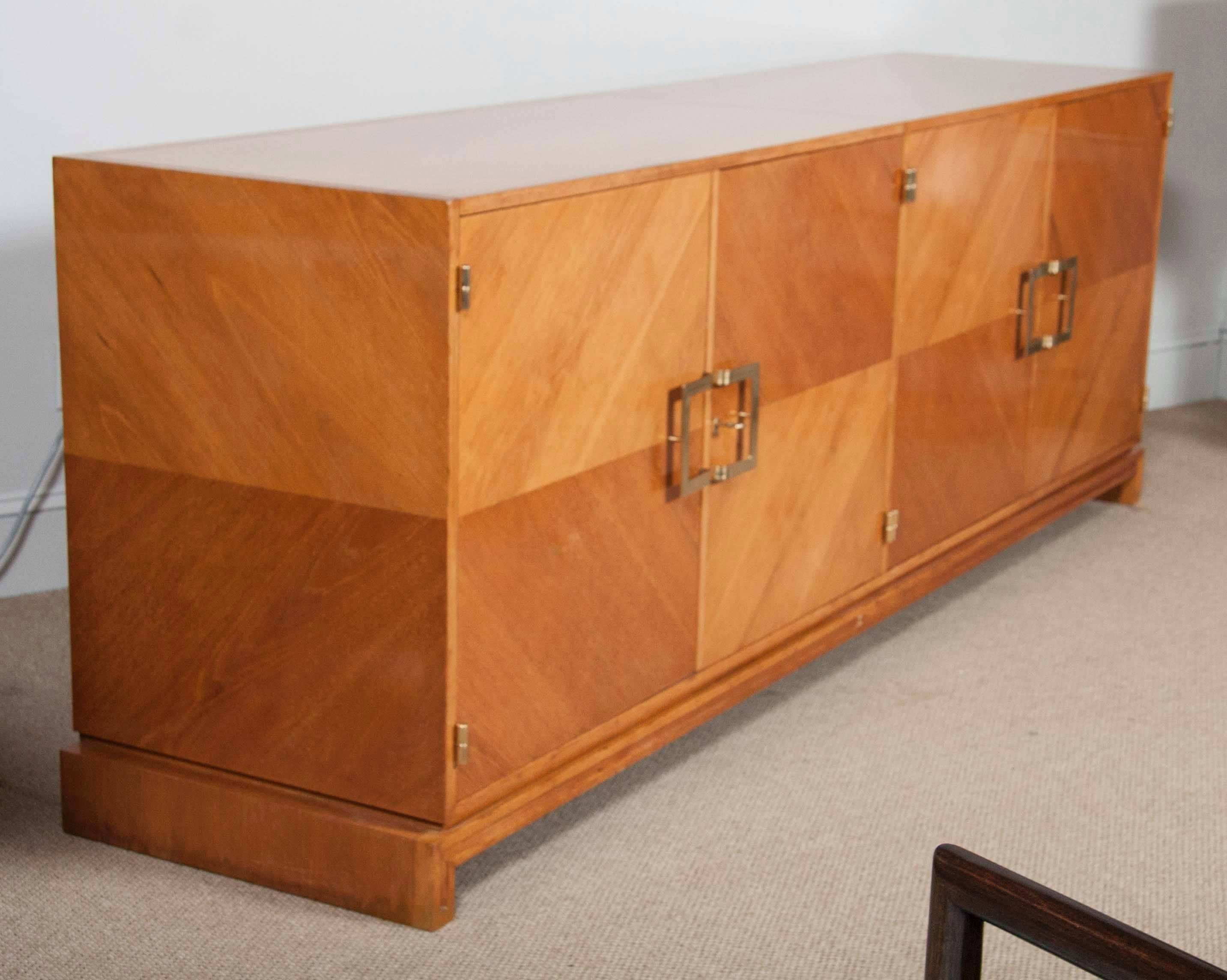 Grand scale walnut and brass cabinet, bar by Parzinger Originals.
Cabinet features four book - matched doors, concealing eight drawers, flip top bar and different storage compartments.
Entire piece has been beautifully restored in natural color