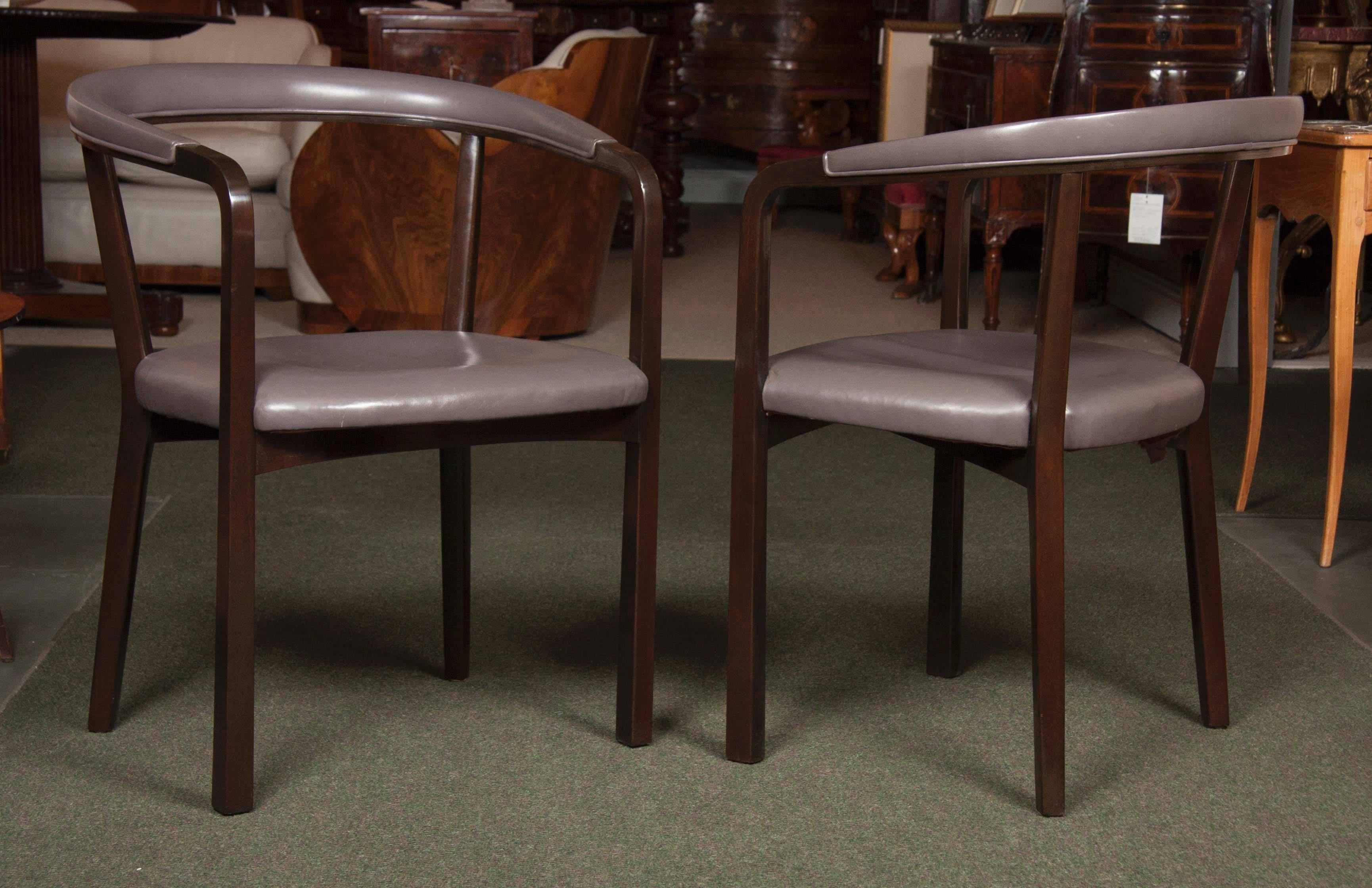 Sculptural pair of Edward Wormley chairs for Dunbar. Walnut frames have been newly refinished in deep chocolate and vintage grey leather is in excellent condition. Great shape and comfort. Both chairs have their metal Dunbar plates intact.