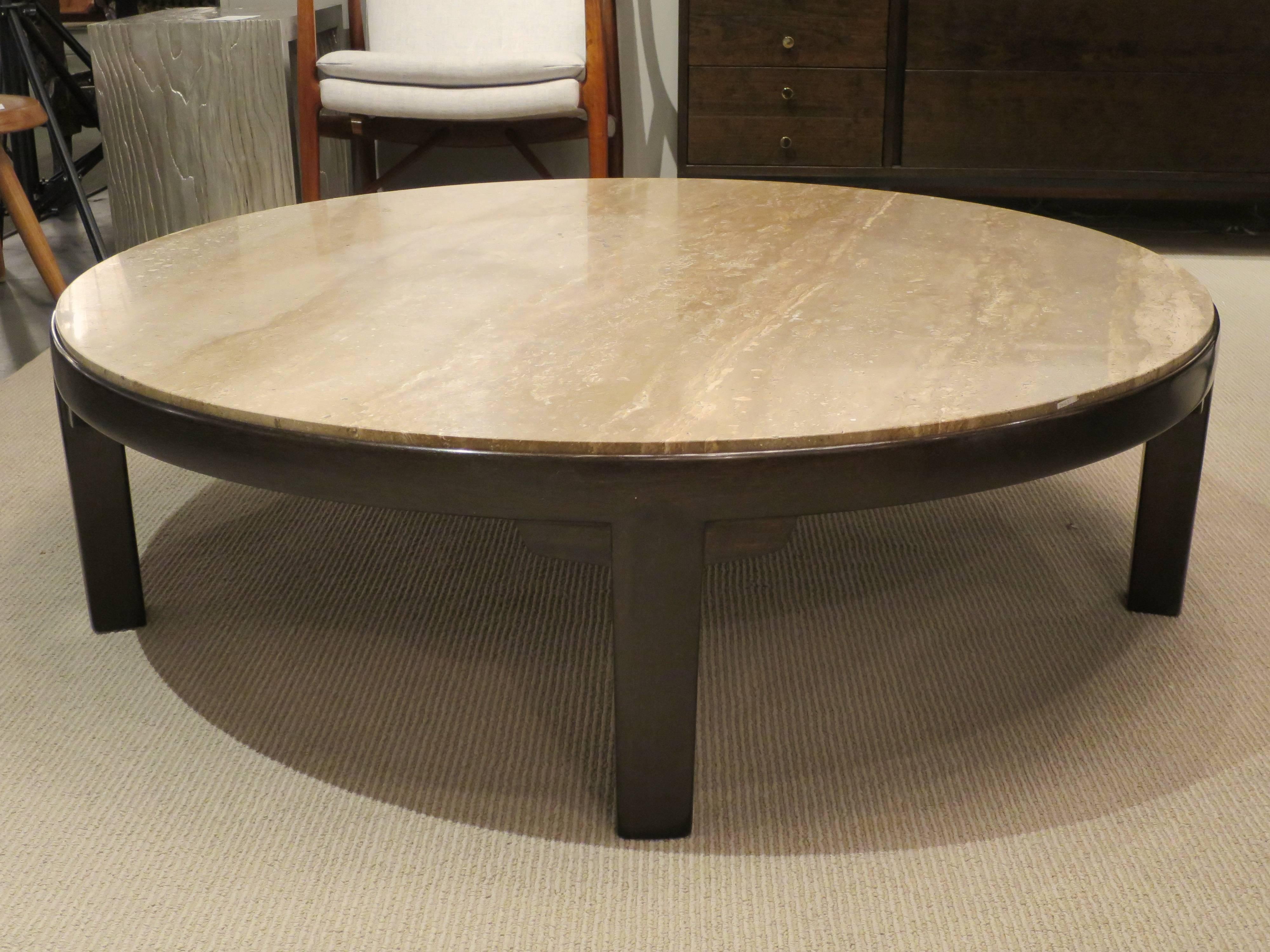 Large-scale round coffee table designed by Edward Wormley for Dunbar, produced in 1950s in Burne, Indiana. Newly refinished mahogany base with original travertine stone top. Metal label underneath. Great modern look and versatility.