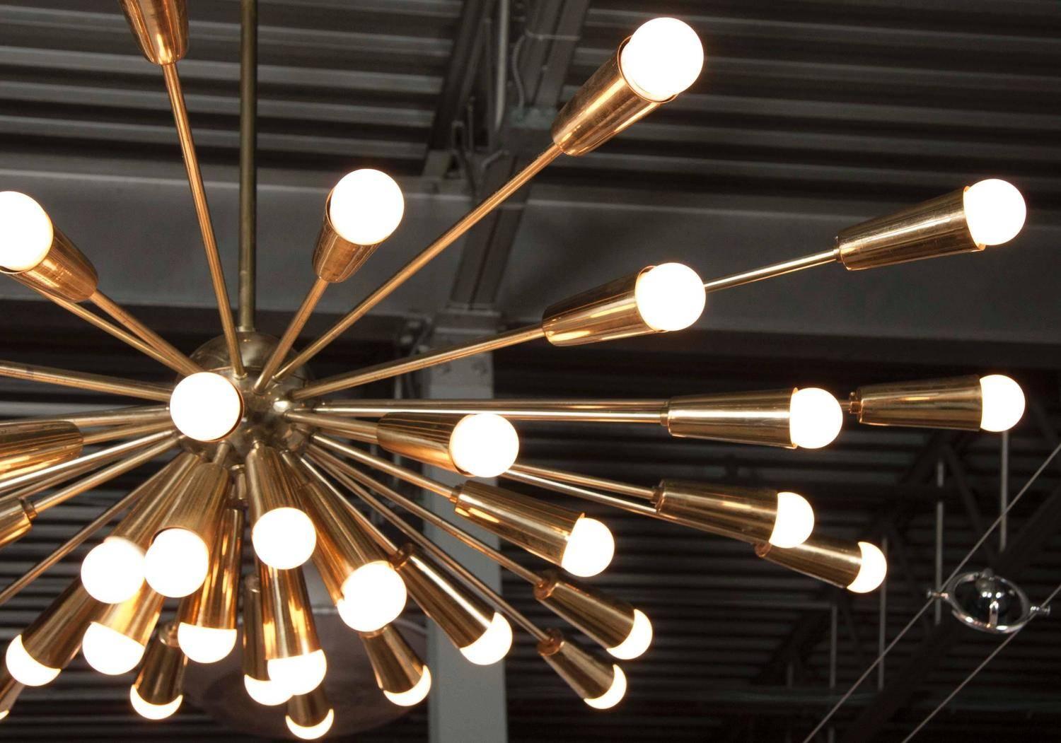 Grand scale brass chandeliers with 40 conical shades in variable lengths, all starting from a brass ball center. Original brass canopy and porcelain sockets intact, Italy, 1960s.
Chandeliers have been newly polished and rewired.

